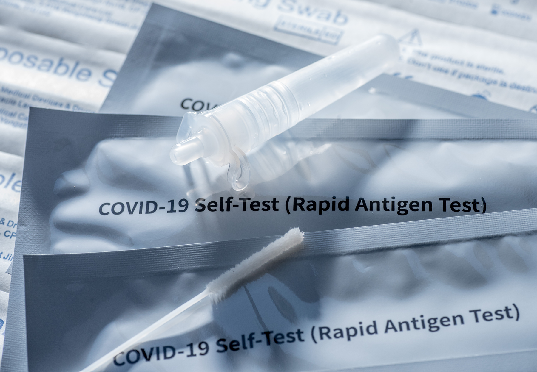 The packaging, swab, and saliva container for a COVID-19 rapid test.
