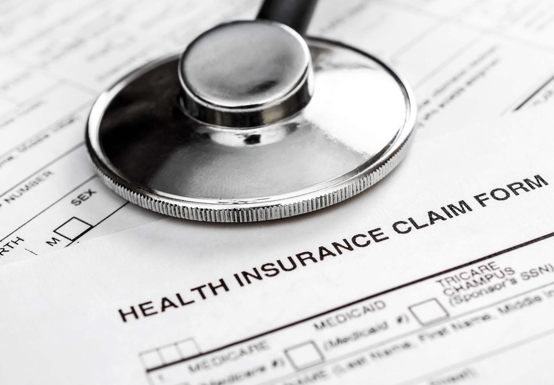 A health insurance claim form with a stethoscope on top of it.