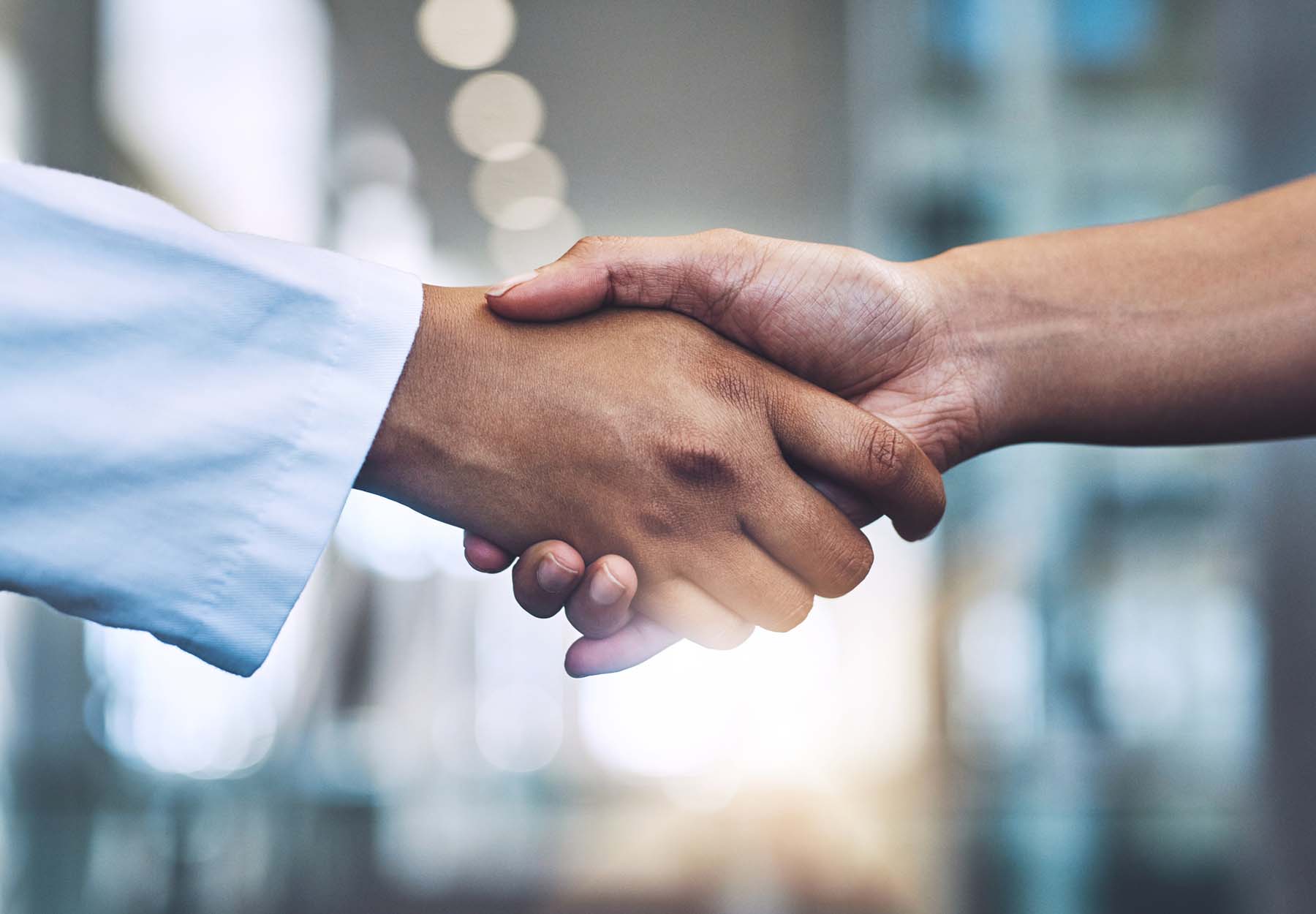 A handshake between lab professionals.