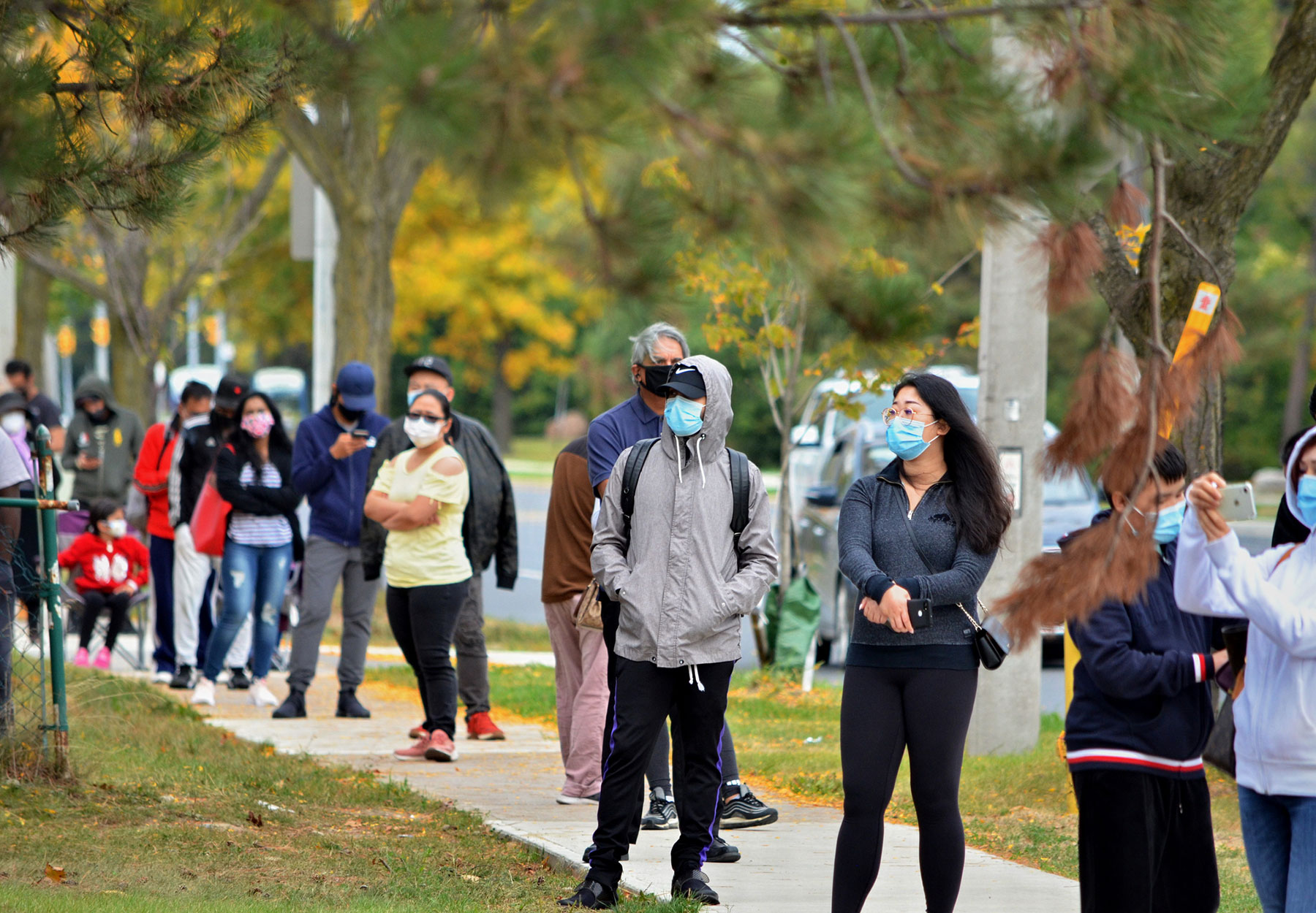 People standing in line to be tested for COVID-19.