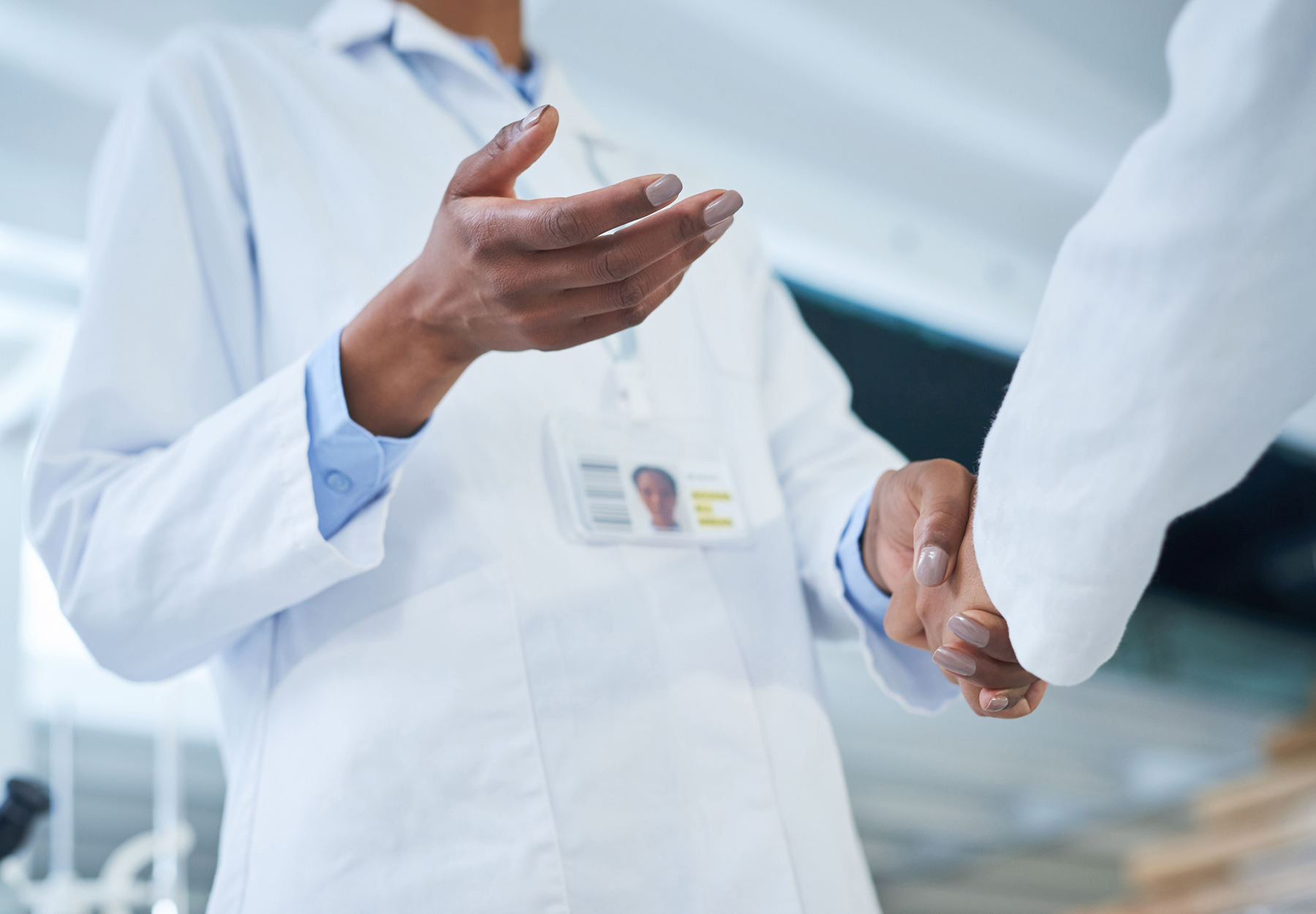 Shot of two unrecognizable scientists shaking hands in a laboratory.