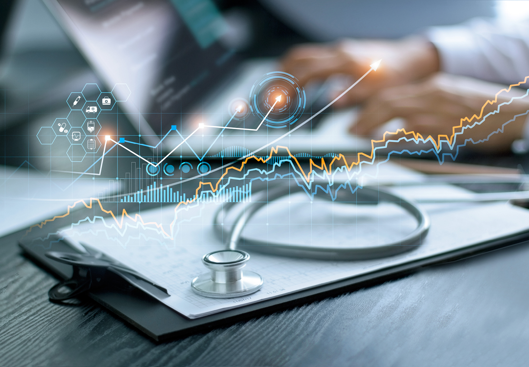 An image of a clipboard with a stethoscope with someone typing on a laptop in the background. There is an overlay of a graph showing numbers rising to illustrate how FCA recoveries are on the rise.