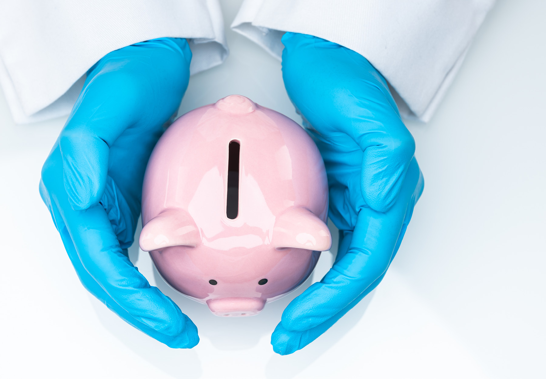 hands in blue medical gloves holding a piggy bank to symbolize COVID1-9 funding