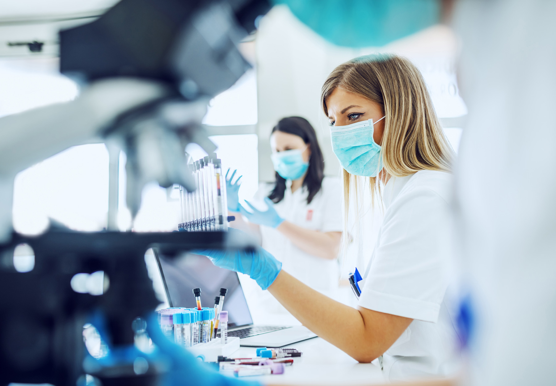 Masked female staff working in a histology lab