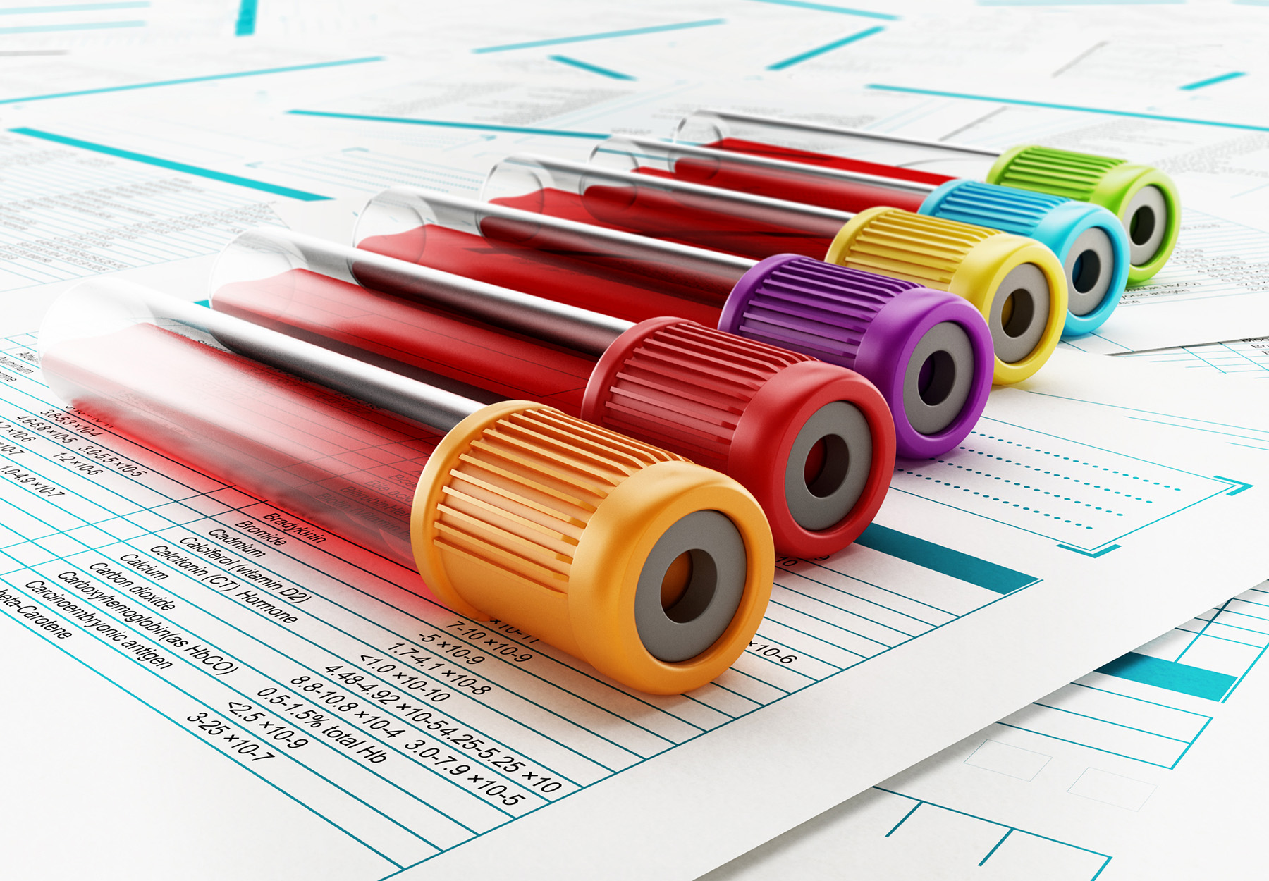 Blood test tubes with multi-colored lids standing on medical documents to represent laboratory tests.