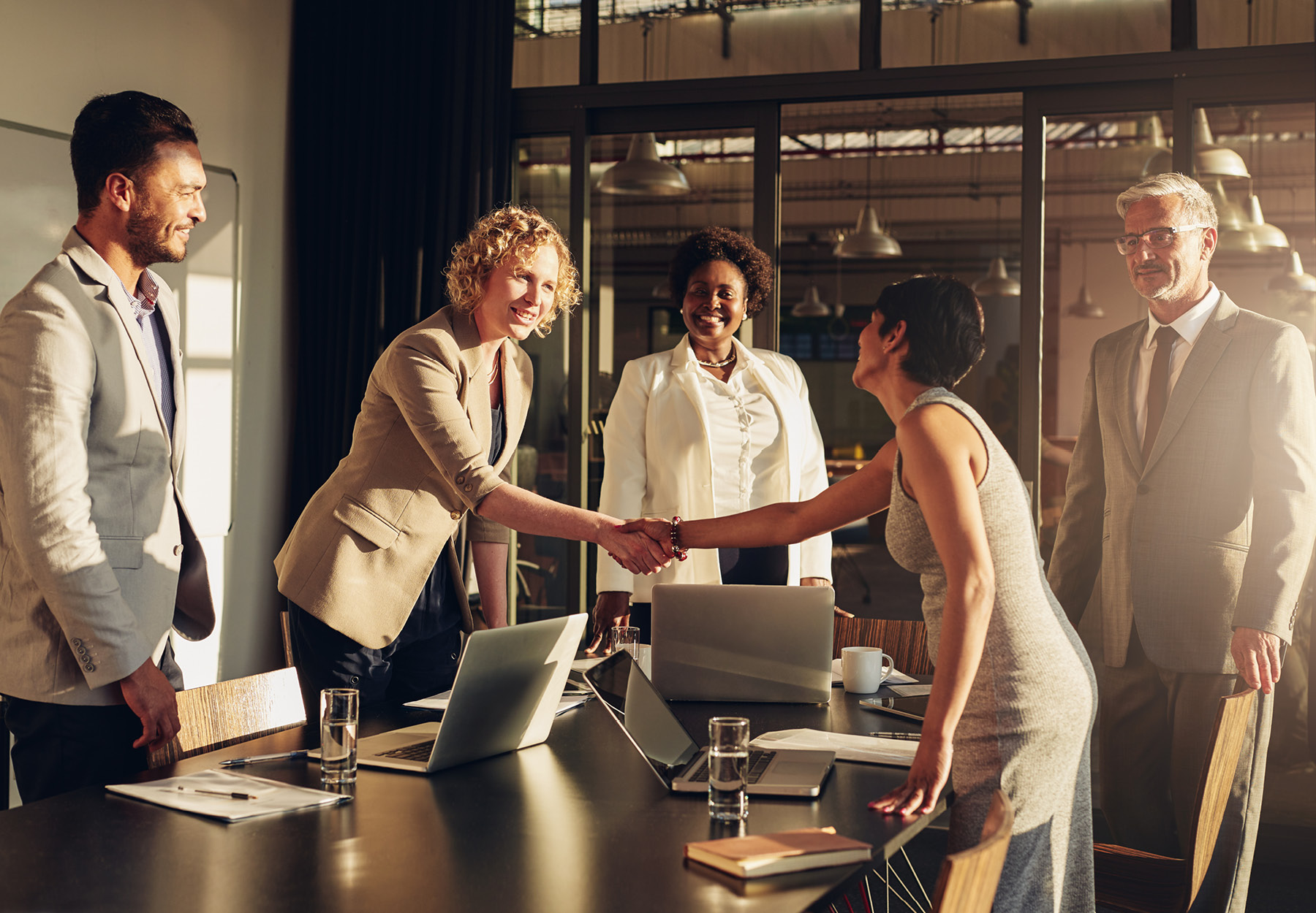 Business people in a boardroom shaking hands