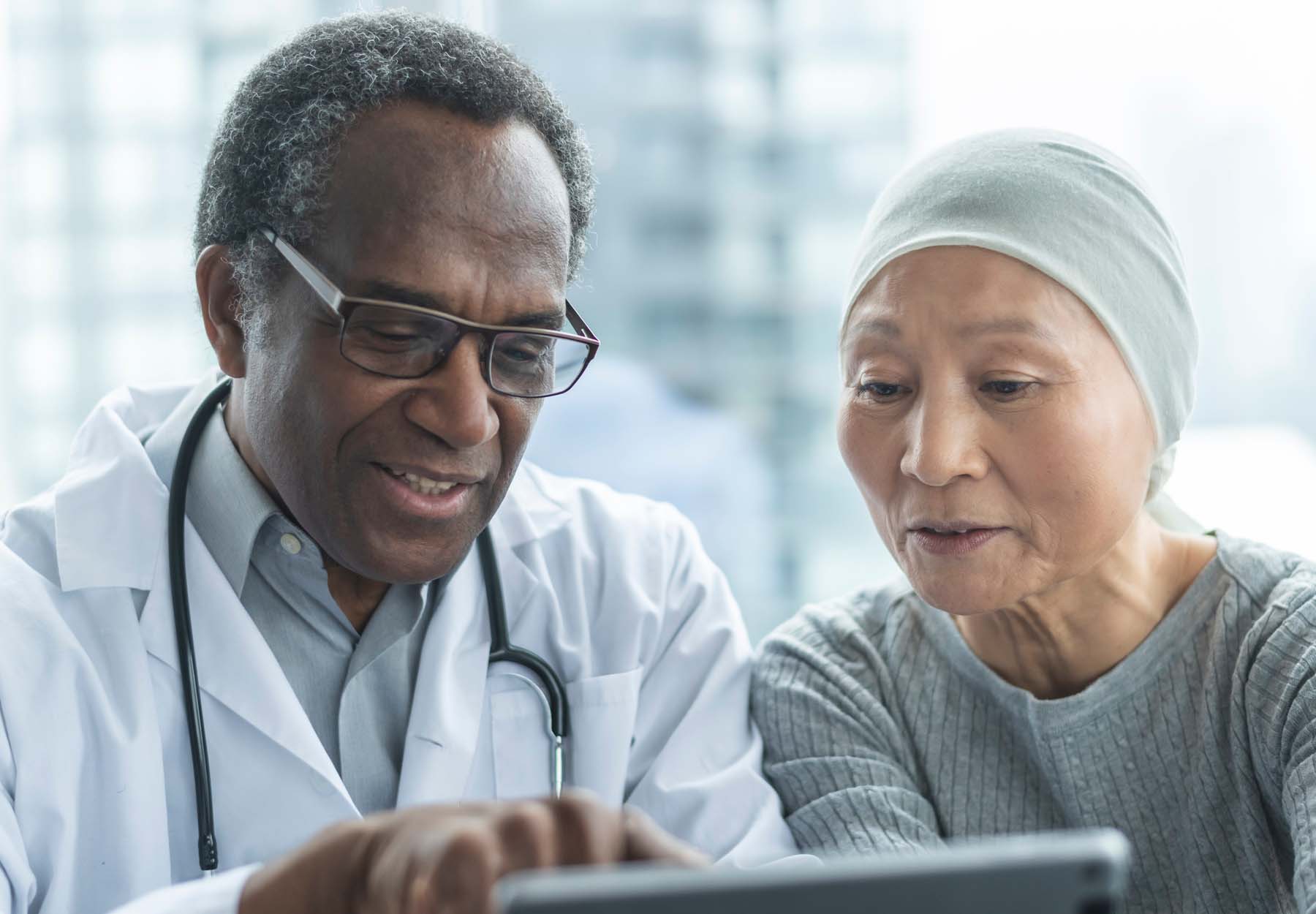 A female cancer patient discusses treatment options with her doctor.