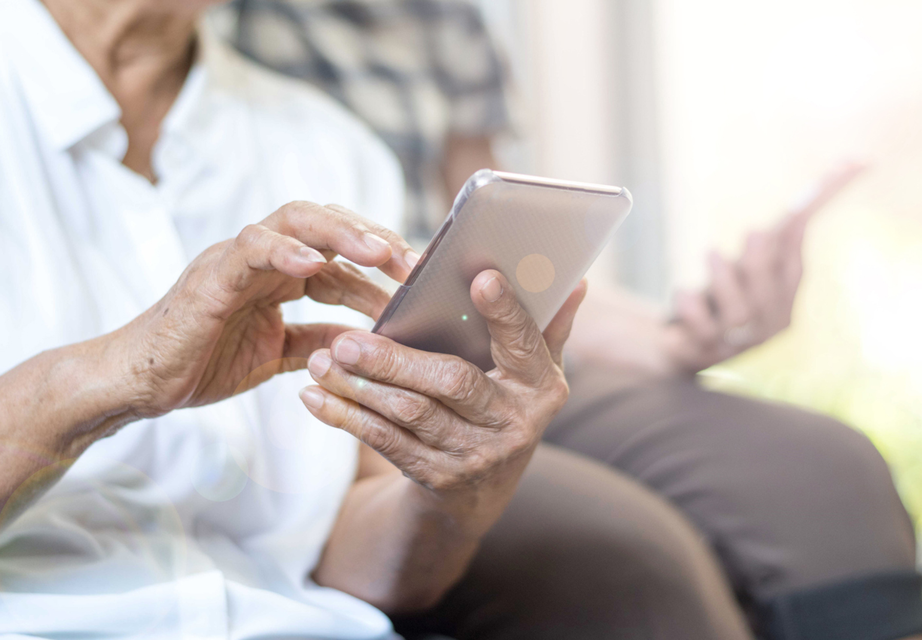 A closeup of an elderly person using a smartphone.