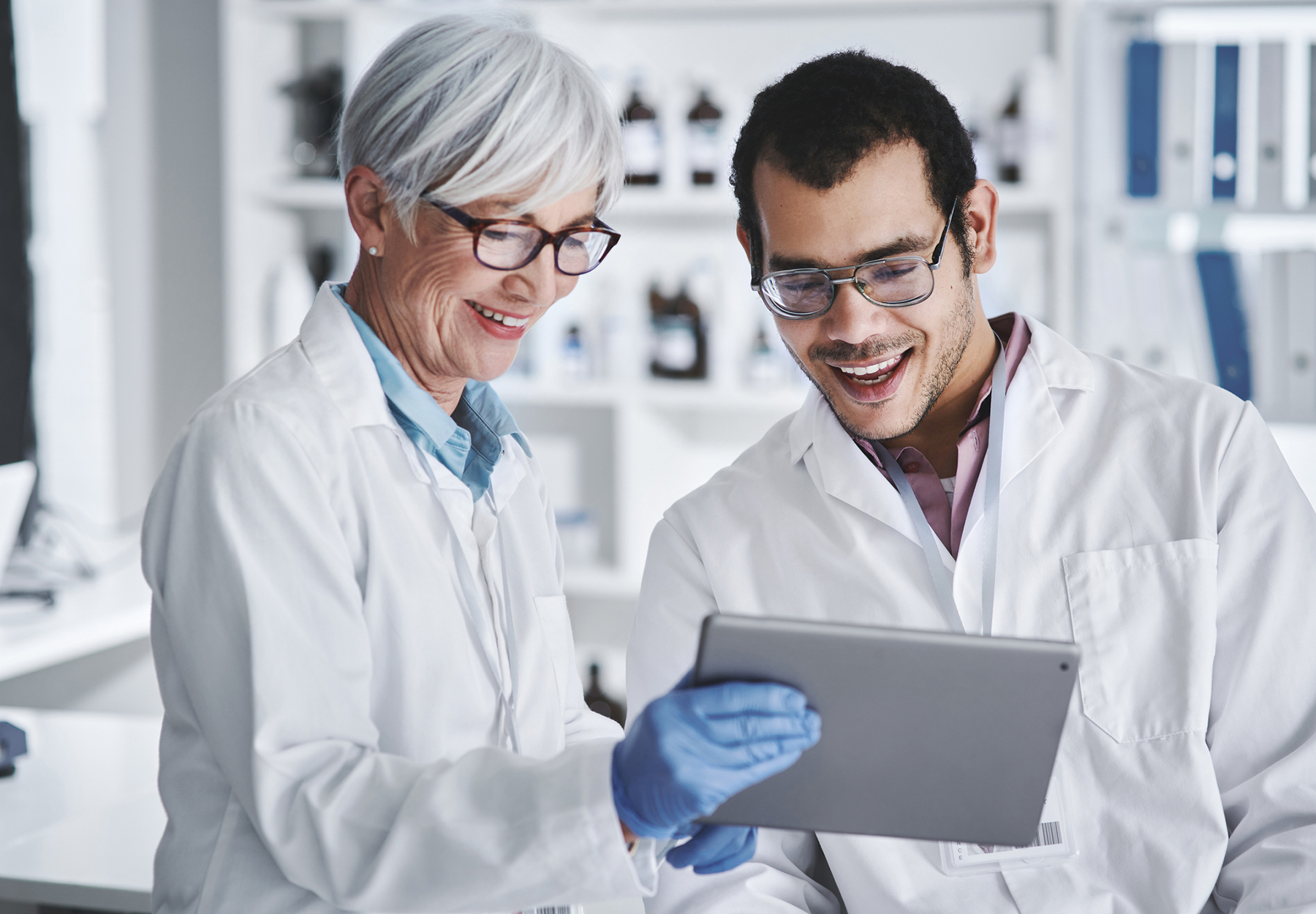 Shot of two scientists working together on a digital tablet in a lab