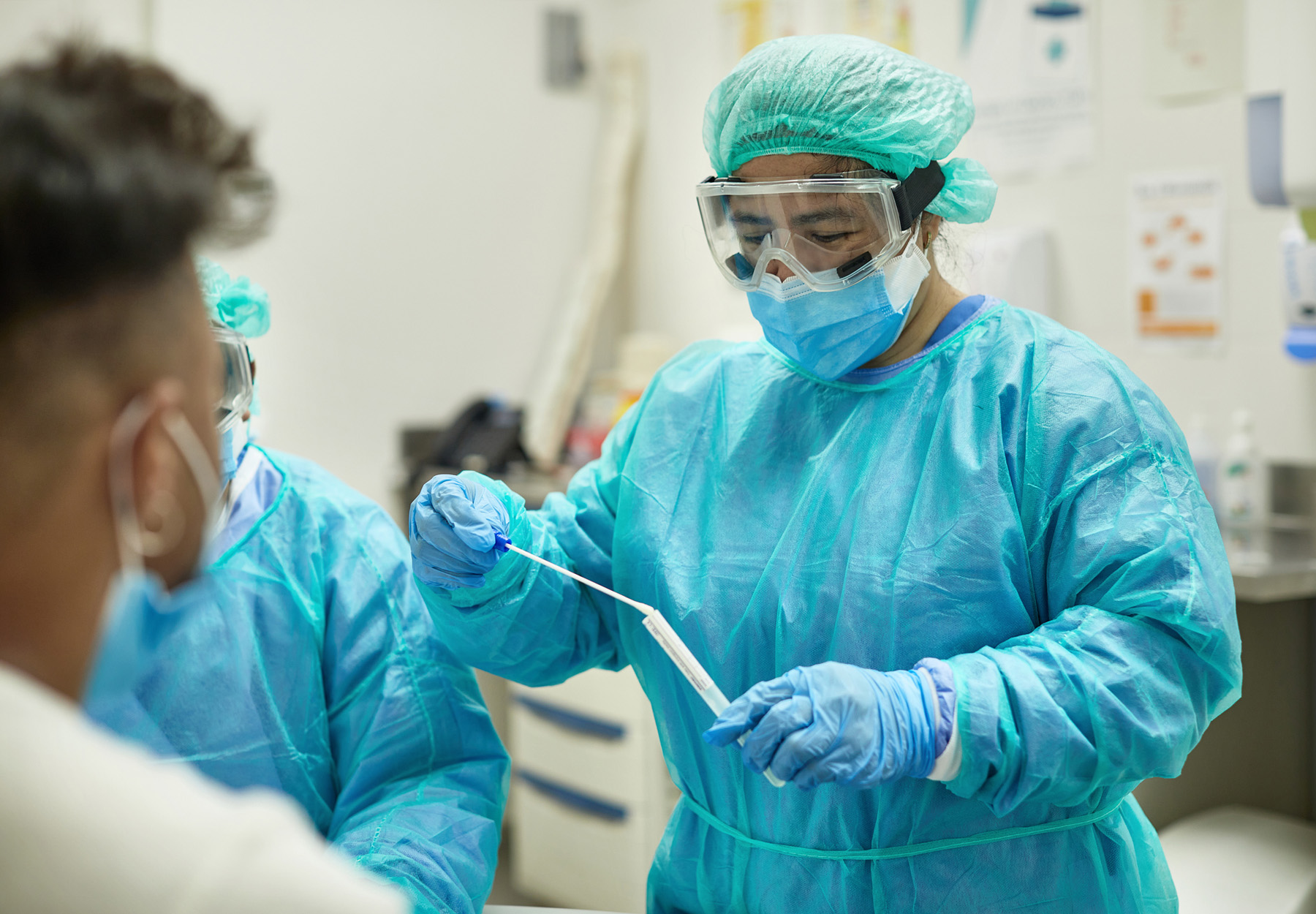 Hospital Nurse Placing Test Swab in Transport Medium stock photo