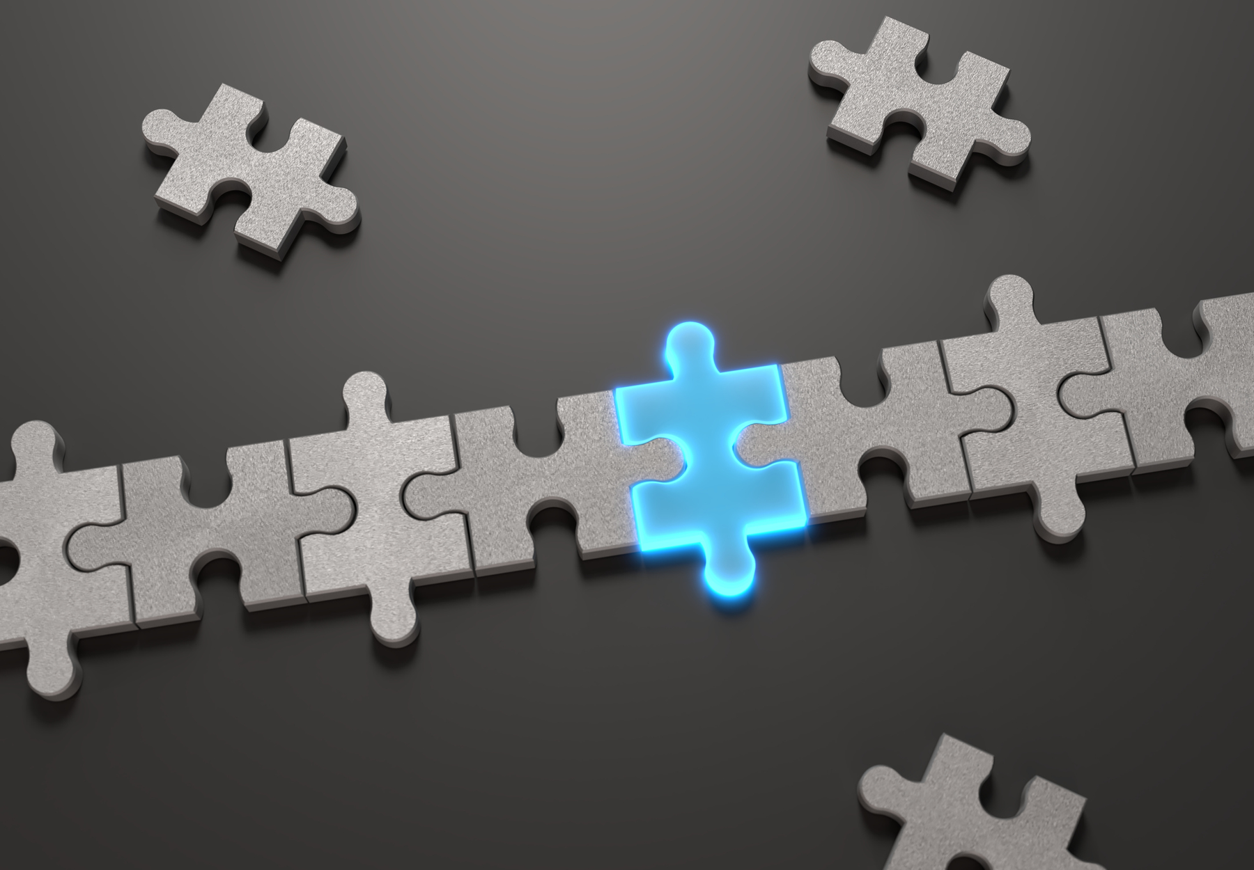A glowing blue puzzle piece among a row of white pieces on a black background to show the concept of mergers and acquisitions