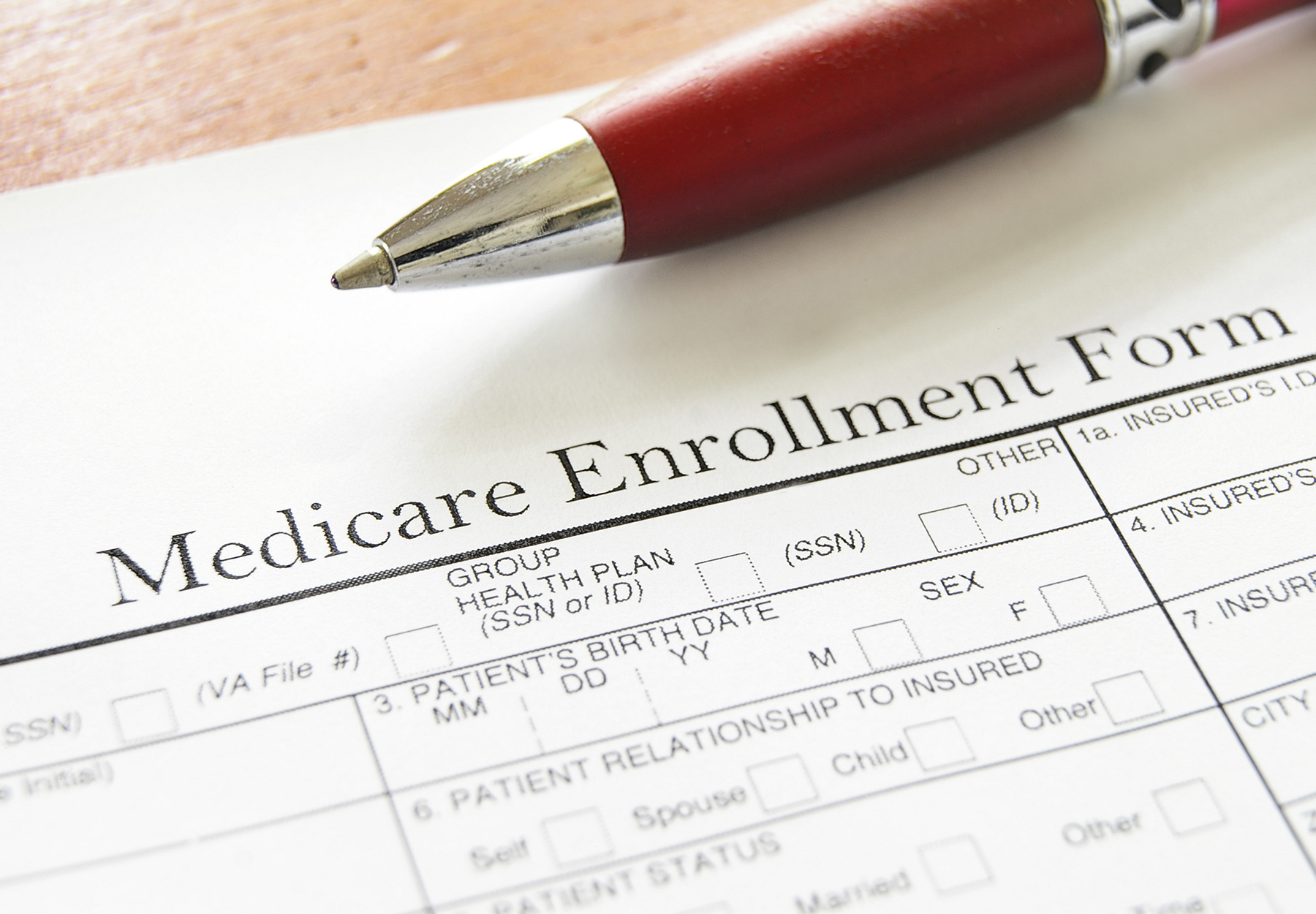 Closeup of Medicare enrollment form and pen