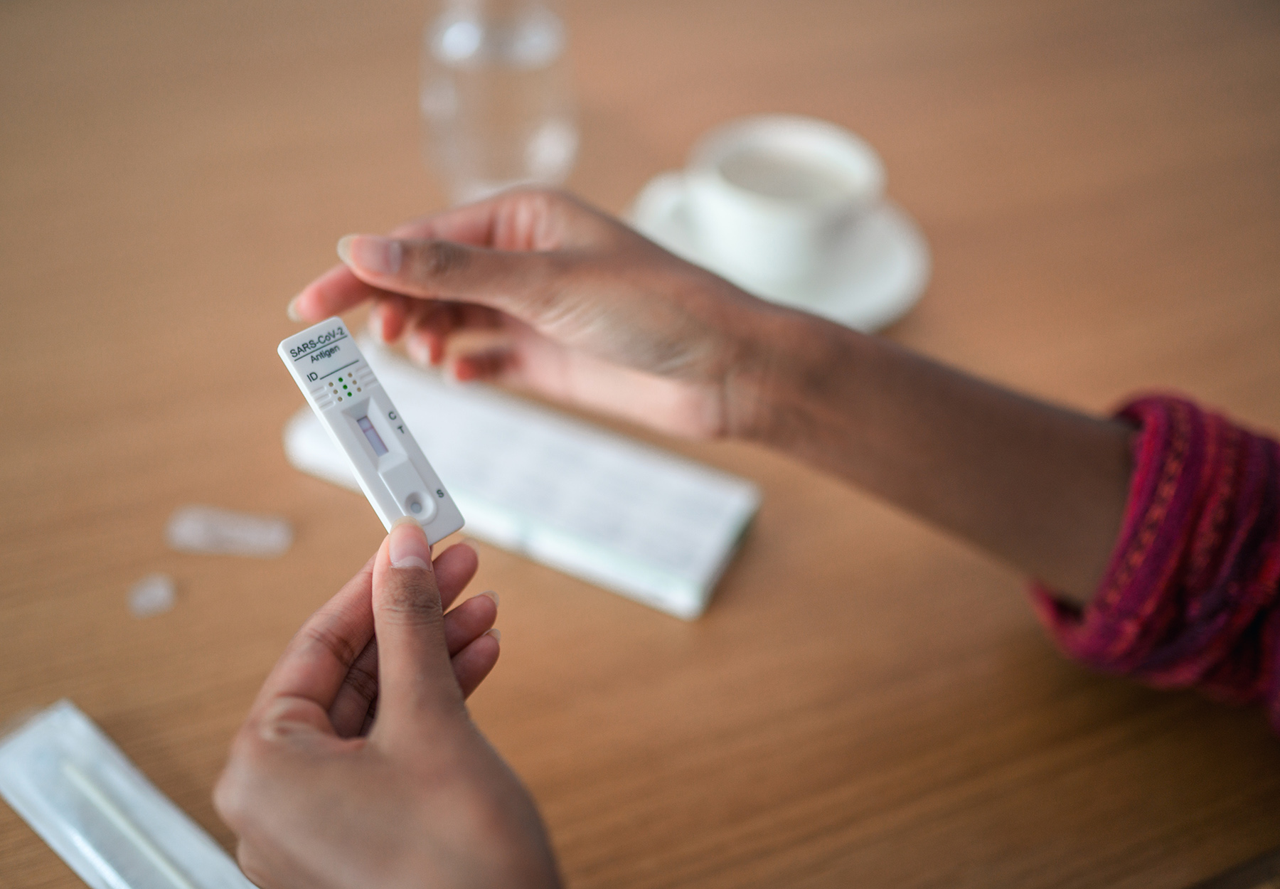 Stock image of Close Up Of Human Hands Holding A Covid Self Test