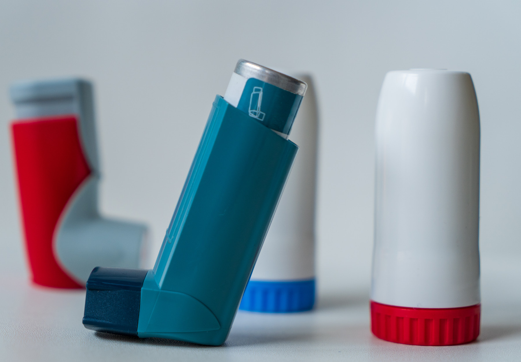 A selection of medication inhalers in a row