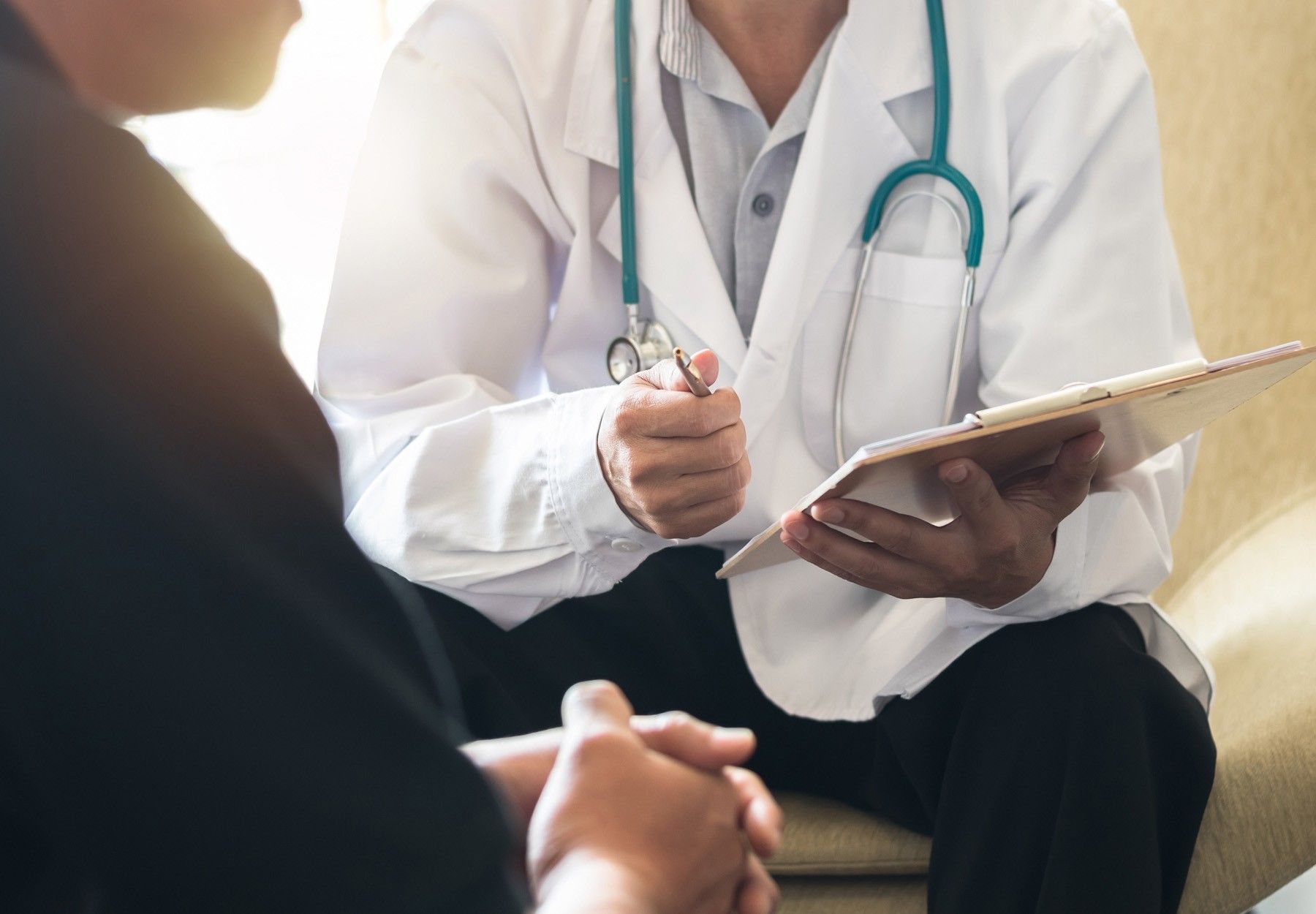 A closeup of a male patient meeting with his doctor stock photo