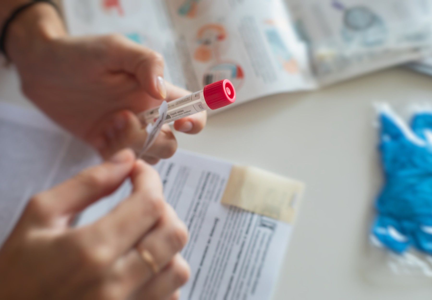 Closeup image of someone opening the packaging of an at-home COVID-19 test