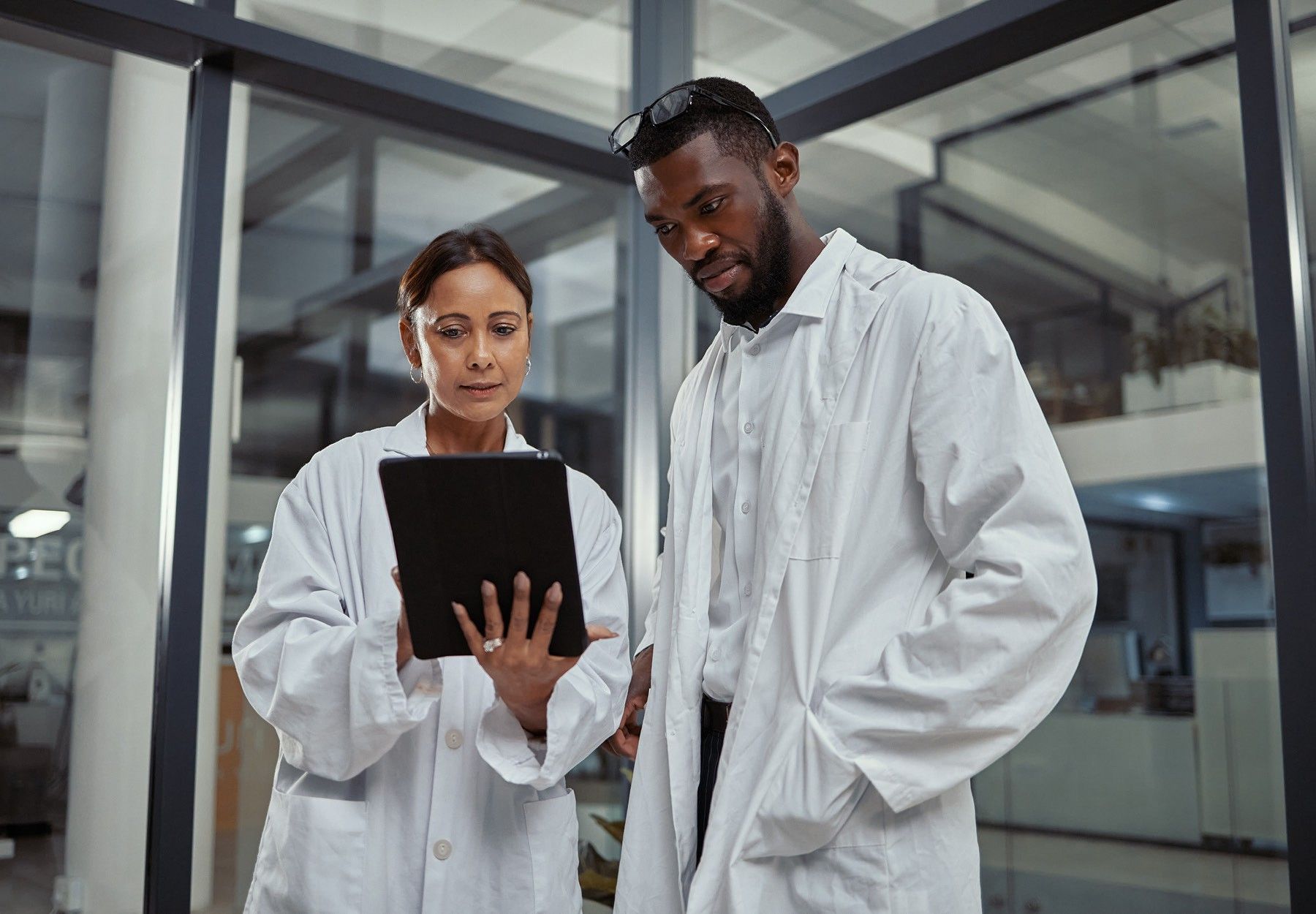 Shot of two scientists working together on a digital tablet stock photo