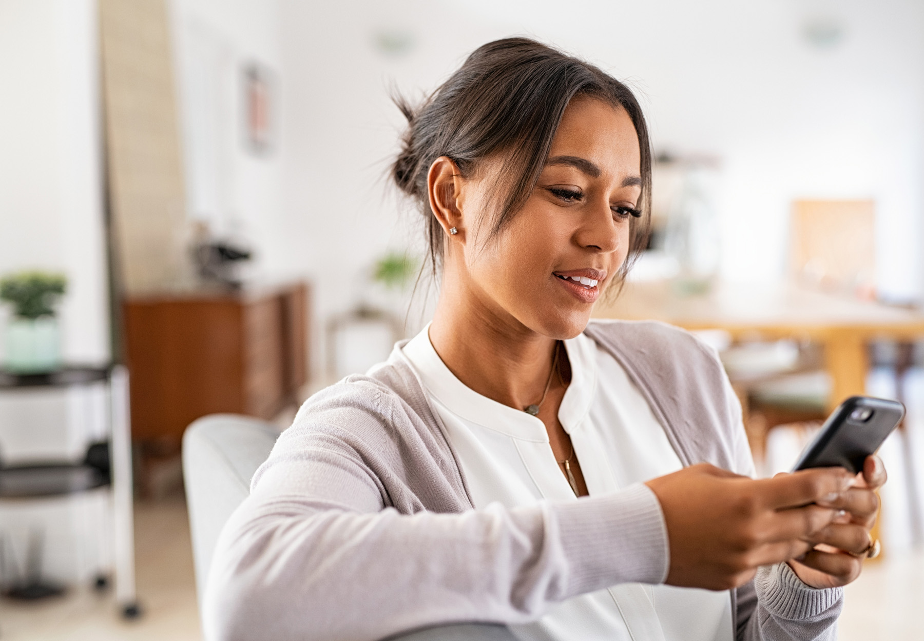 Woman using smartphone at home