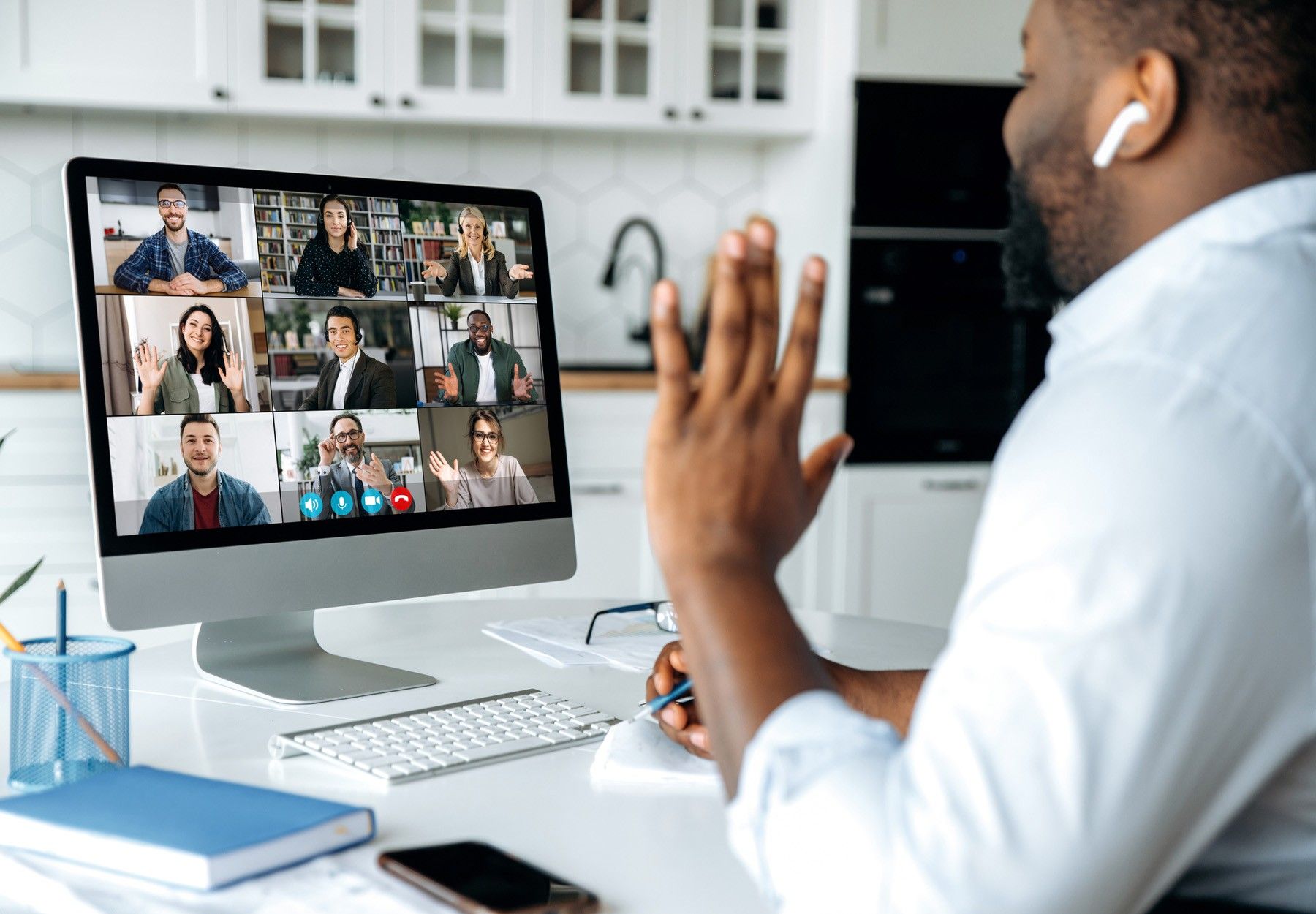 Over shoulder view of african american man at computer screen with multinational group of successful business people, virtual business meeting, work from home concept stock photo