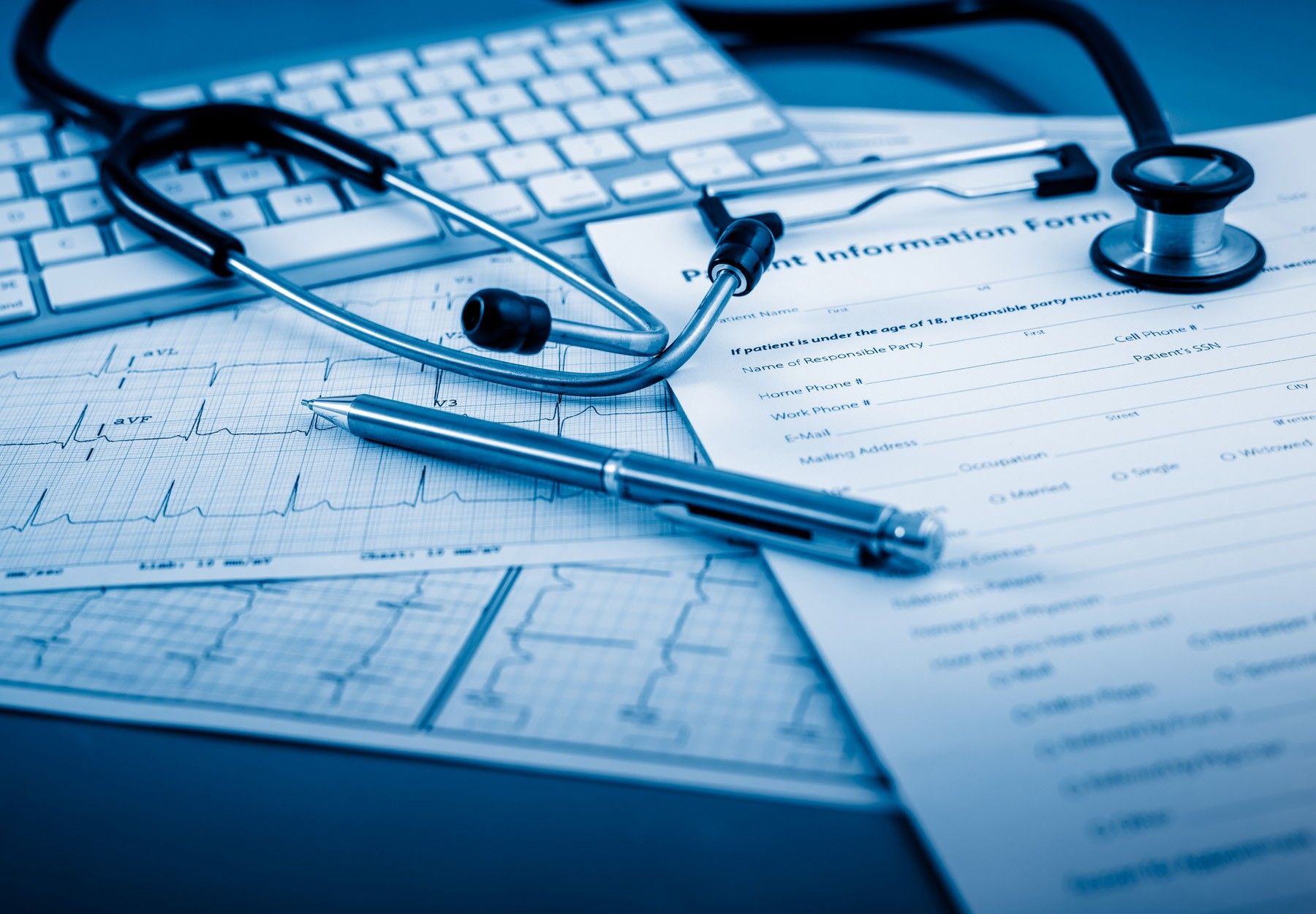 Documents and stethoscope on desk to symbolize improper billing