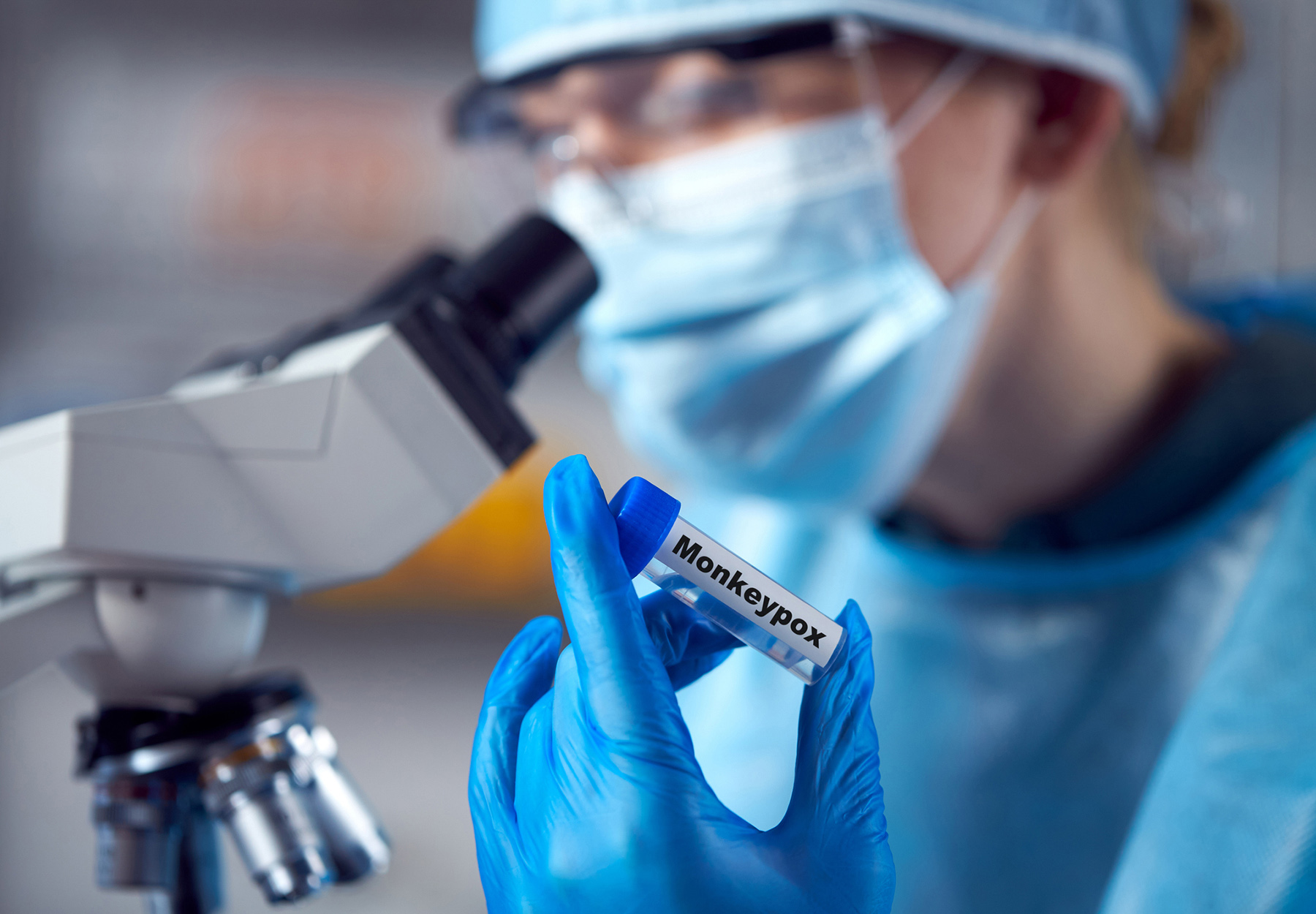 Female Lab Research Worker Wearing PPE Holding Test Tube Labeled Monkeypox. Stock Image.