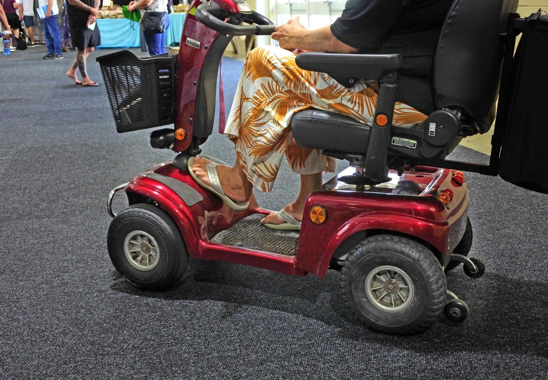 A closeup of an elderly woman in a power mobility device stock photo