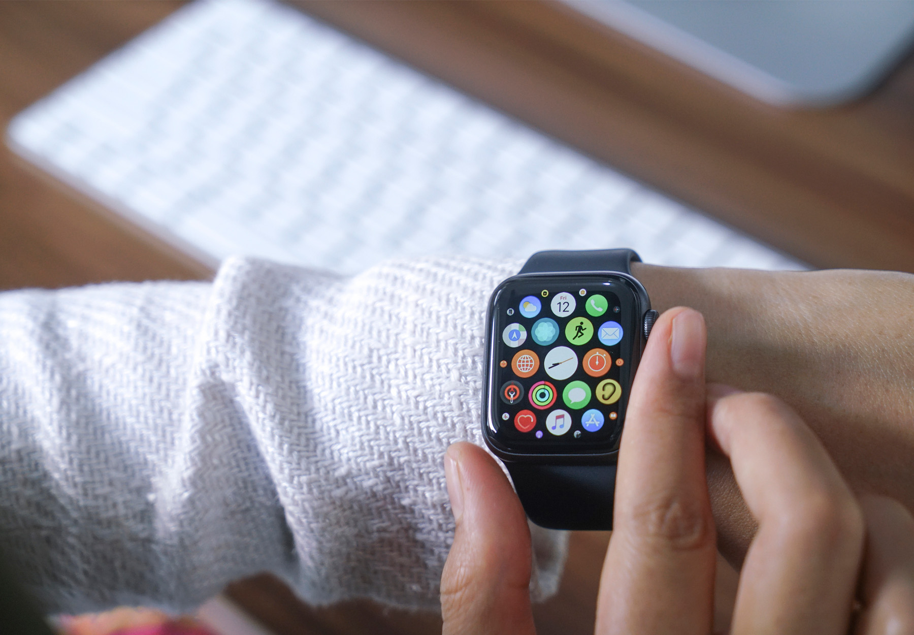 Stock image of a closeup of female hands using an Apple Watch