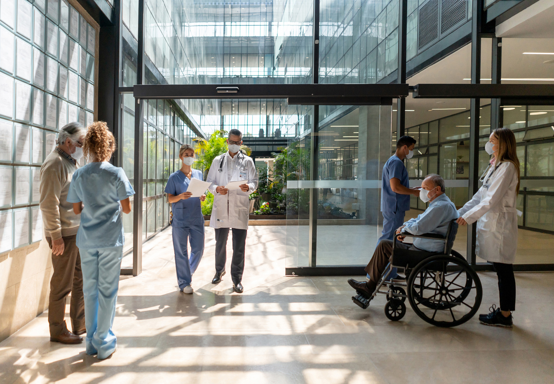 Stock image of people walking in and out of the hospital