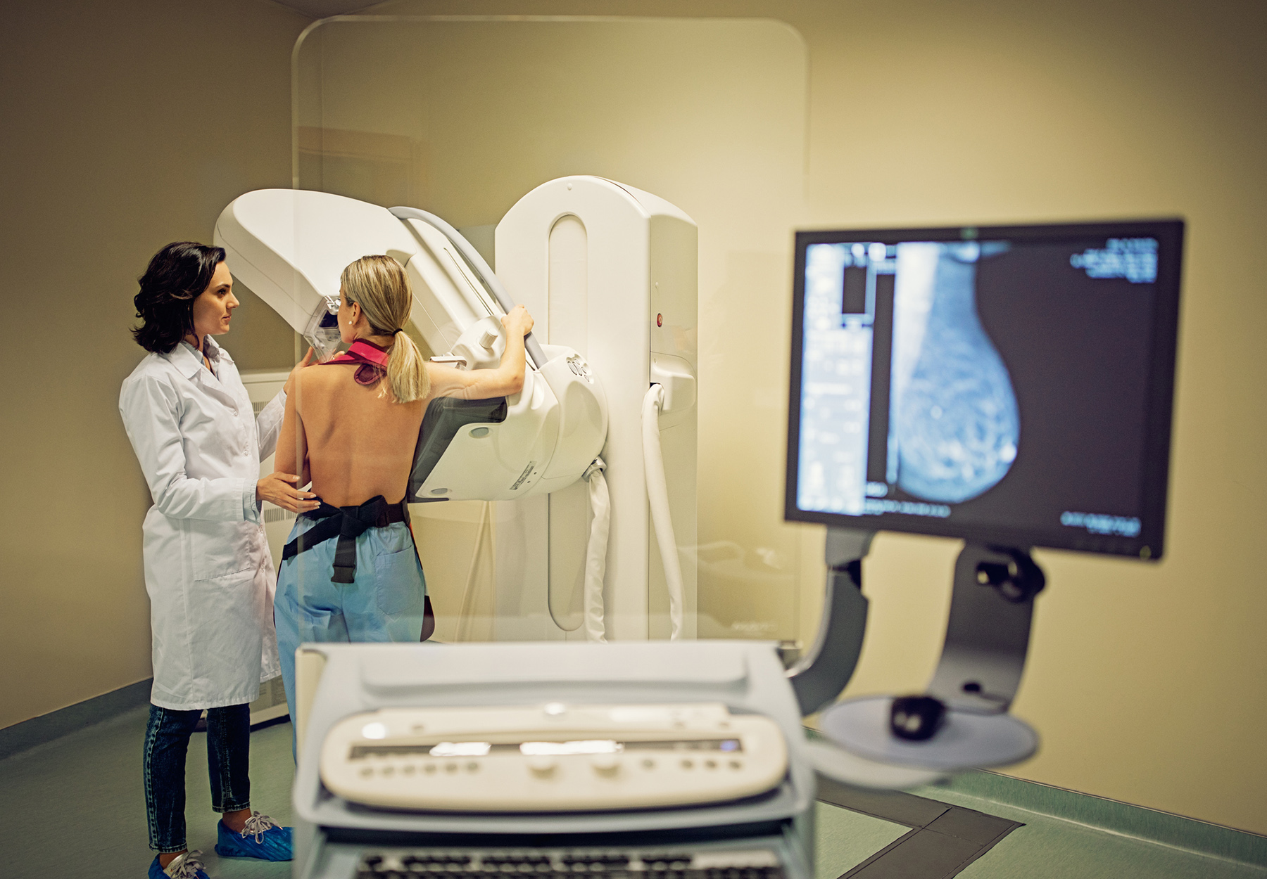 A woman gets a mammogram from a doctor in this stock image.