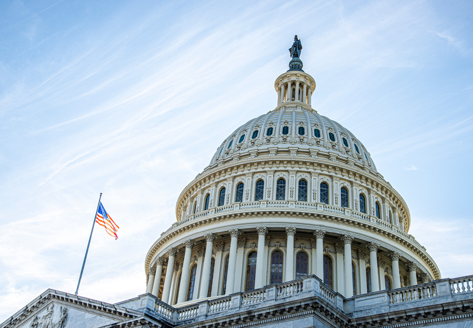 A stock photo of the US Capitol Building with a blue sky in the background