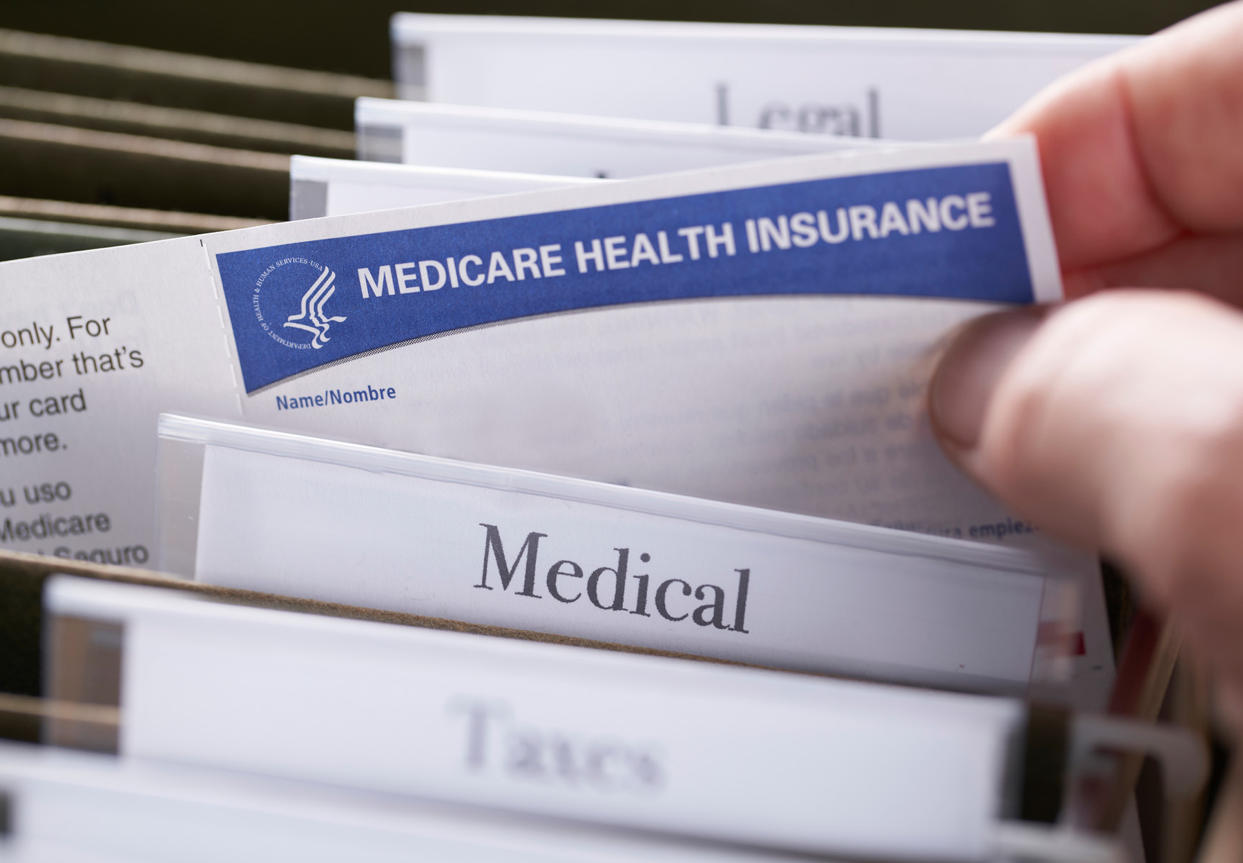 edicare Health Insurance card in file folder. Stock photo.