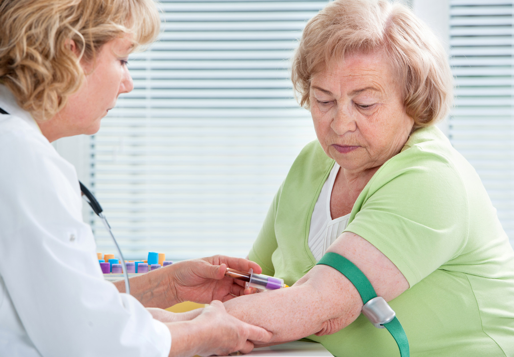 Elderly woman getting a blood test. Stock photo.
