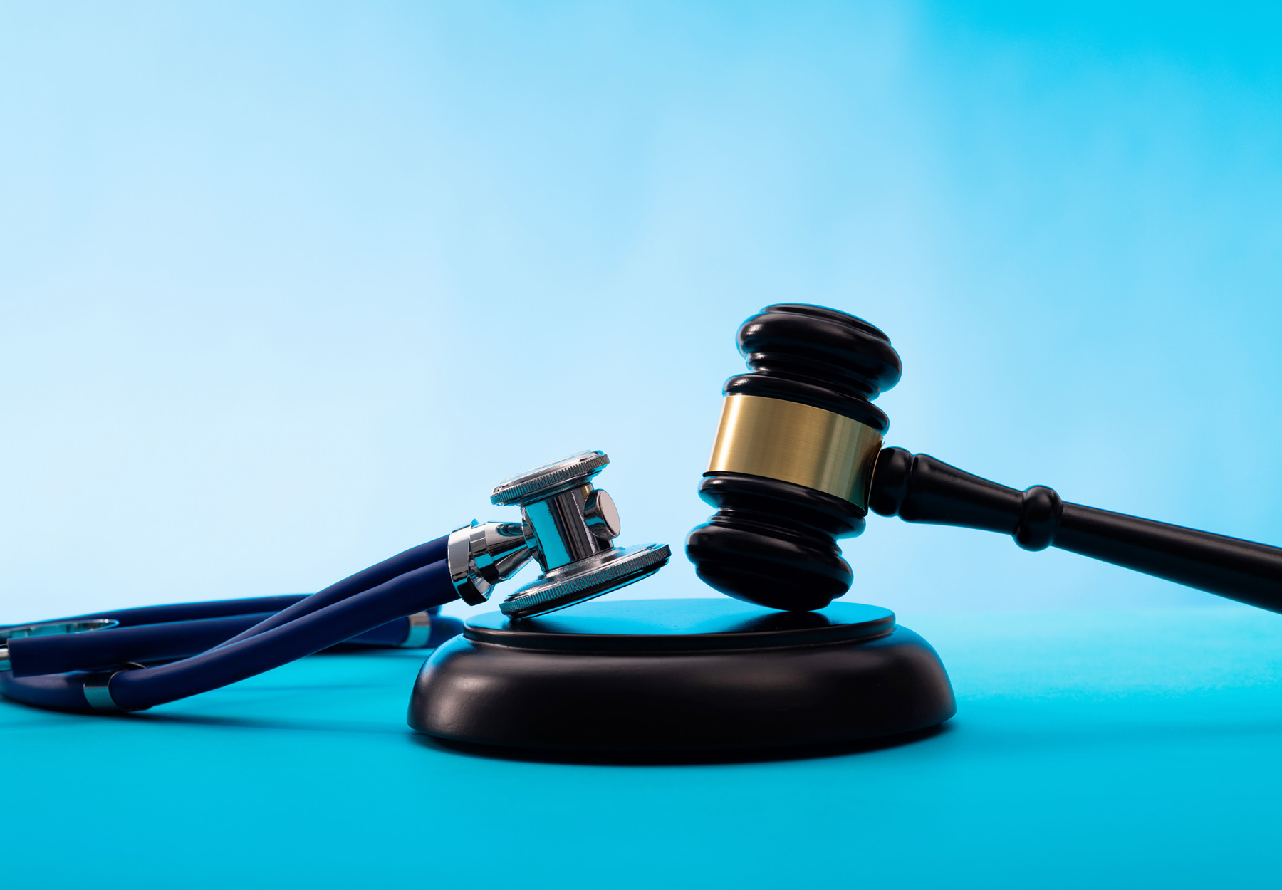 Judge's gavel and stethoscope on a blue background. Stock image.