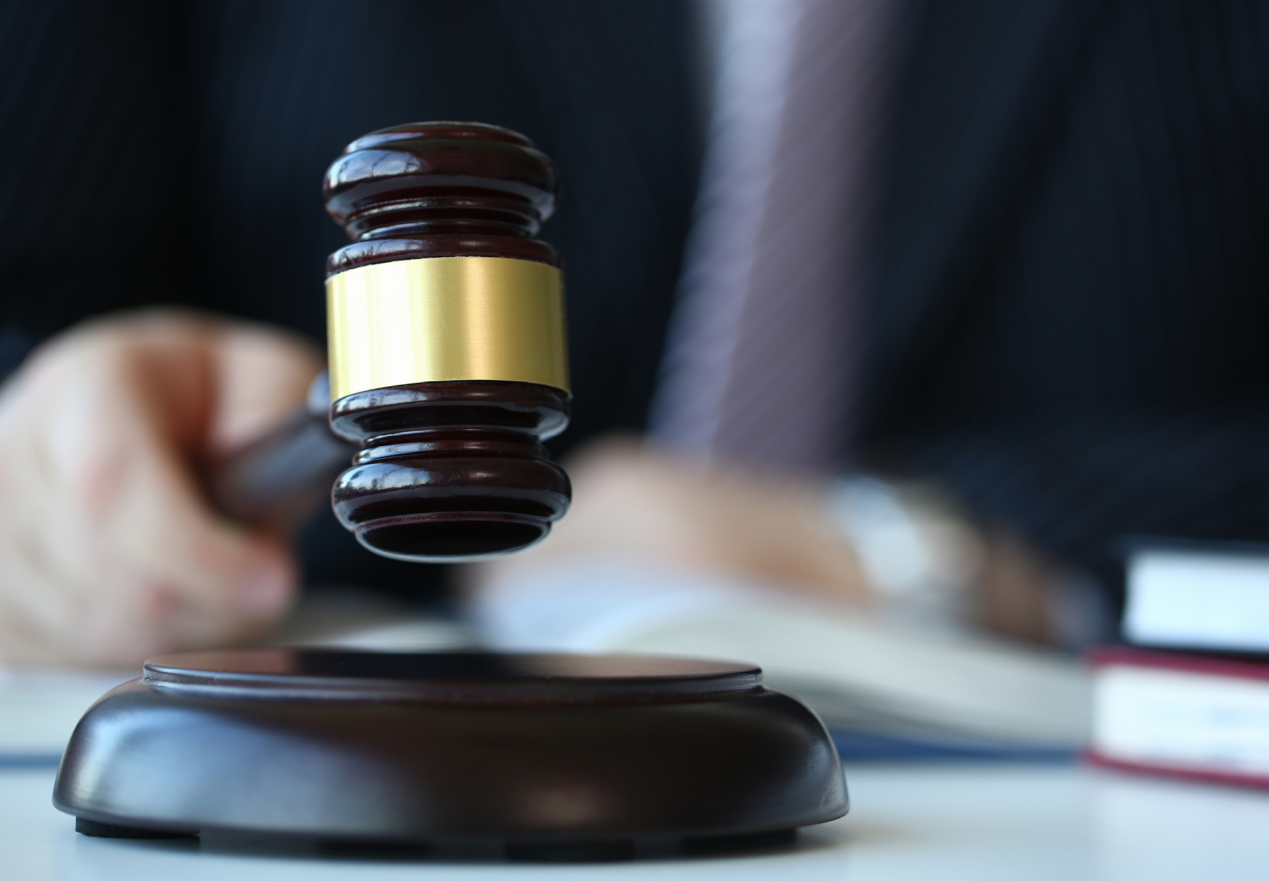 A closeup of a judge using a gavel. Stock photo.