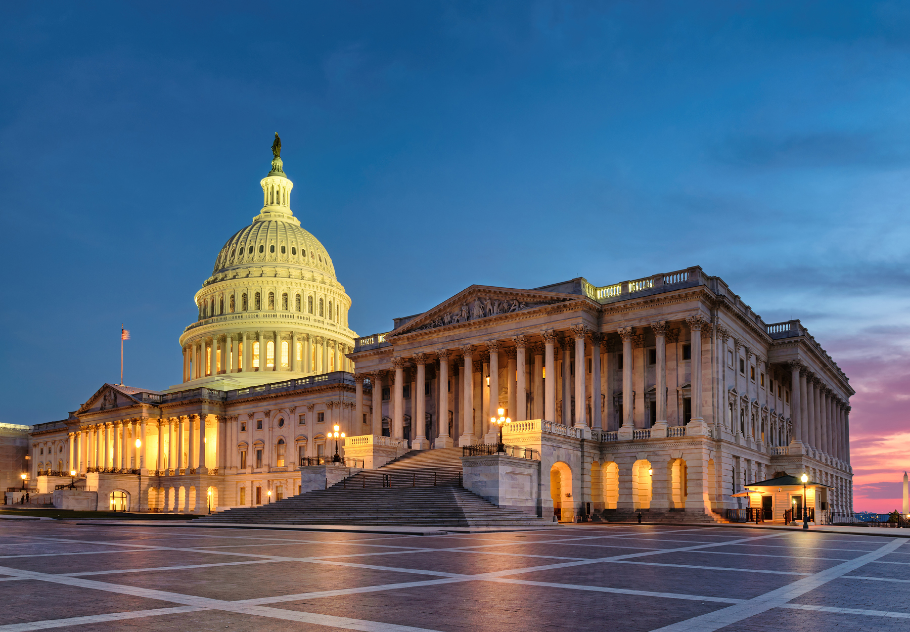 The United States Capitol building lit up at at night. Stock photo.