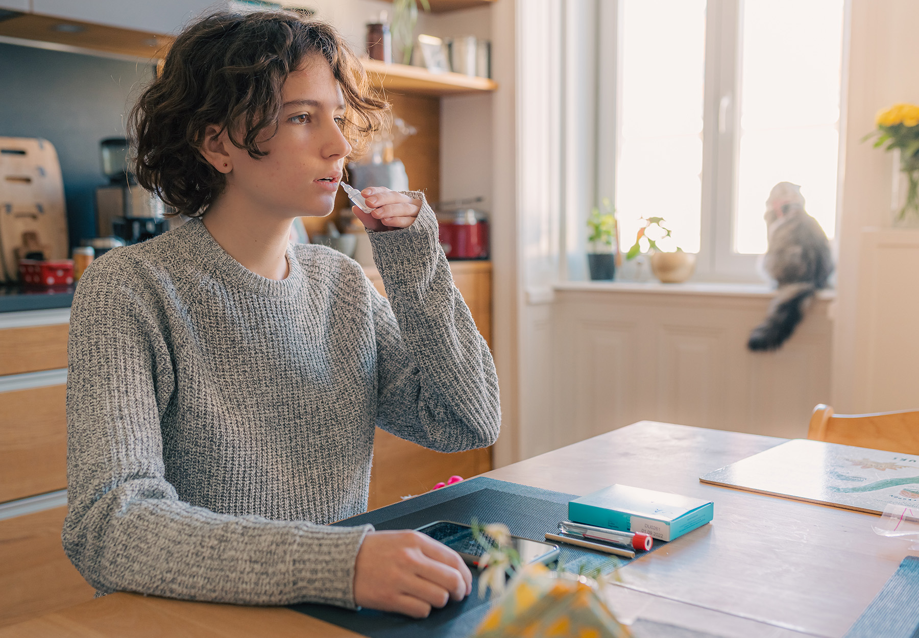 Teenager doing an at-home COVID-19 saliva test. iStock image.