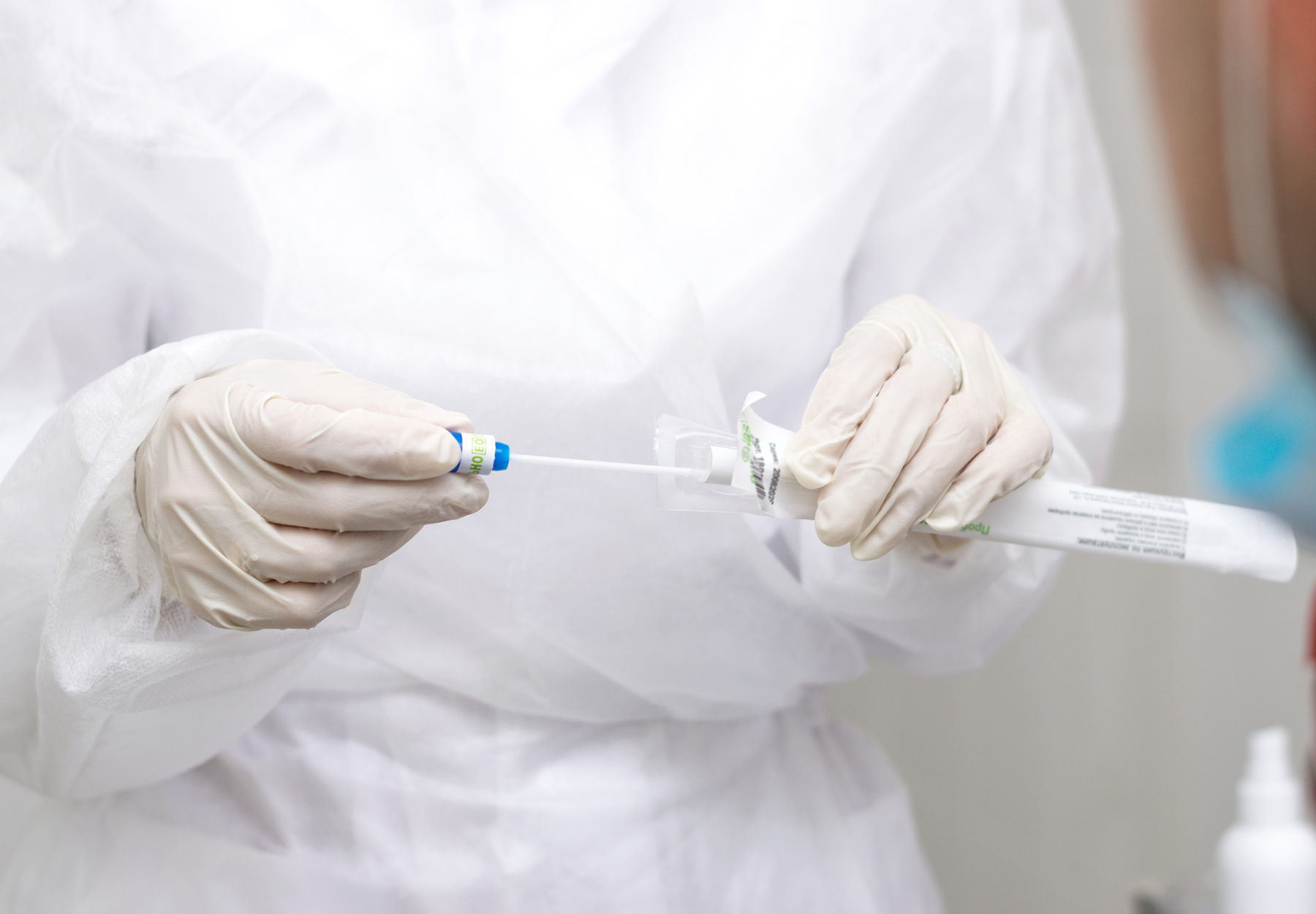 A medical worker opens a package with a cotton swab for a coronavirus test, hands close-up. Medical and coronavirus concept. iStock image.