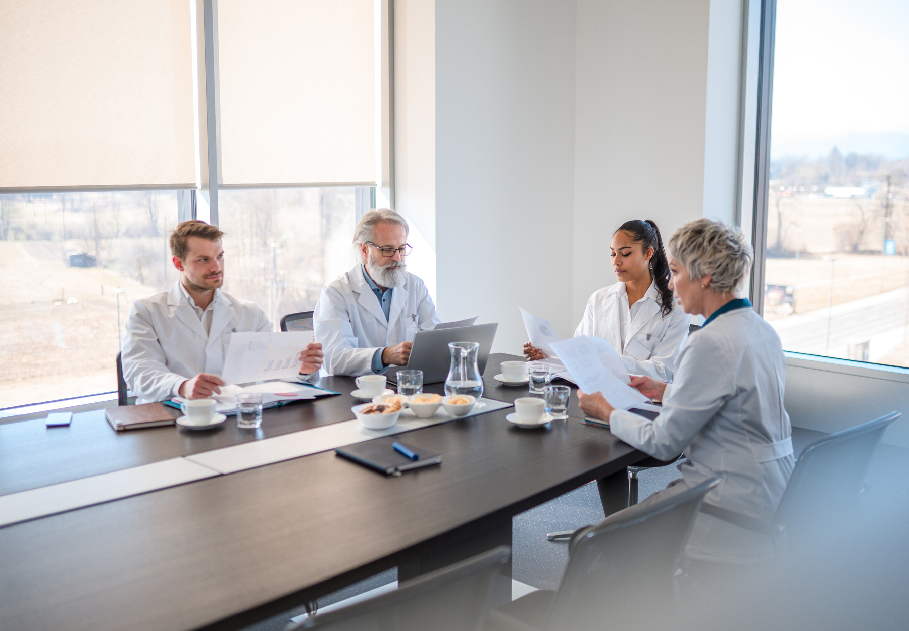 Group of laboratory board members meeting in a boardroom in an office building. iStock image.