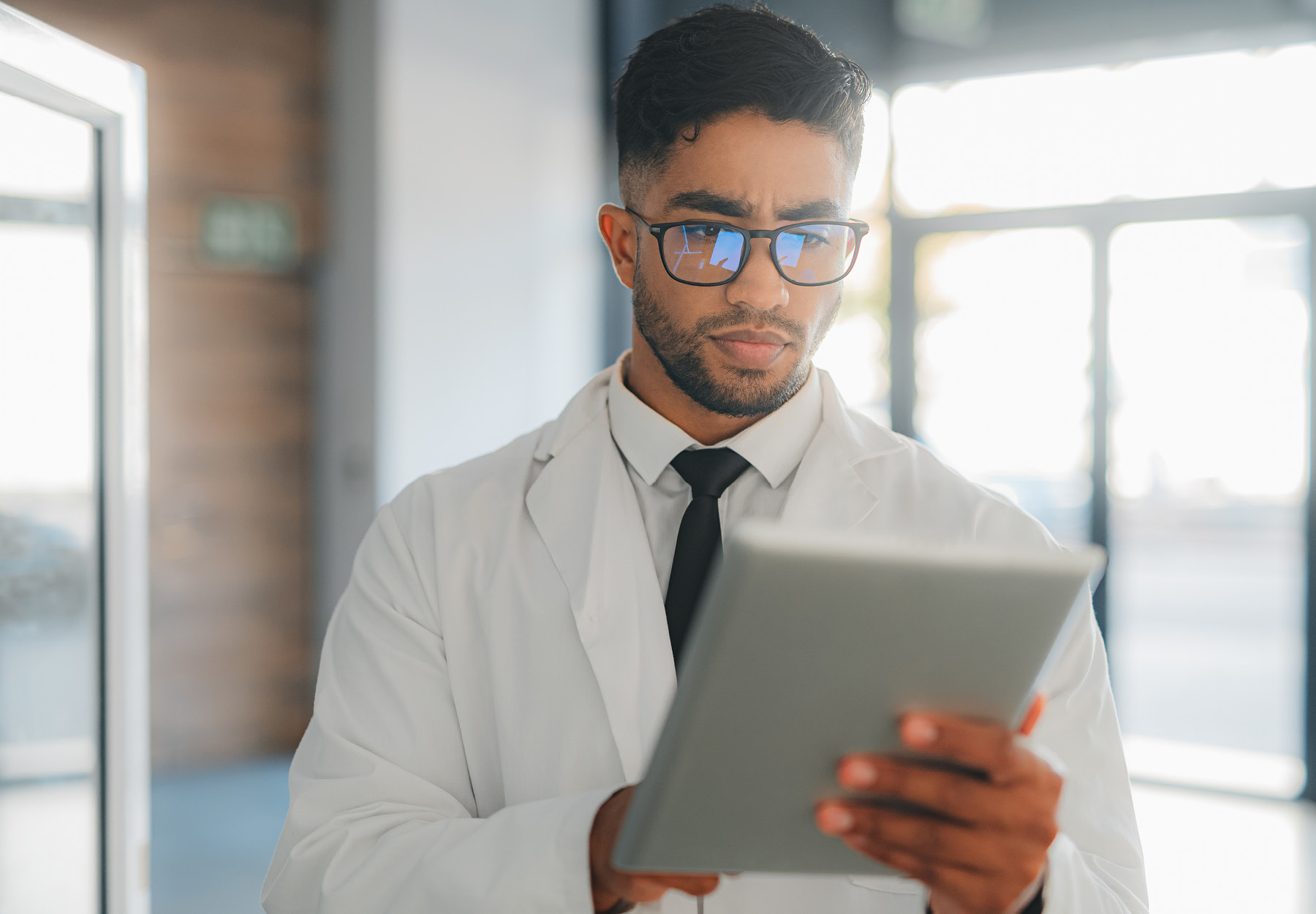 Scientist with digital tablet checking results, iStock image