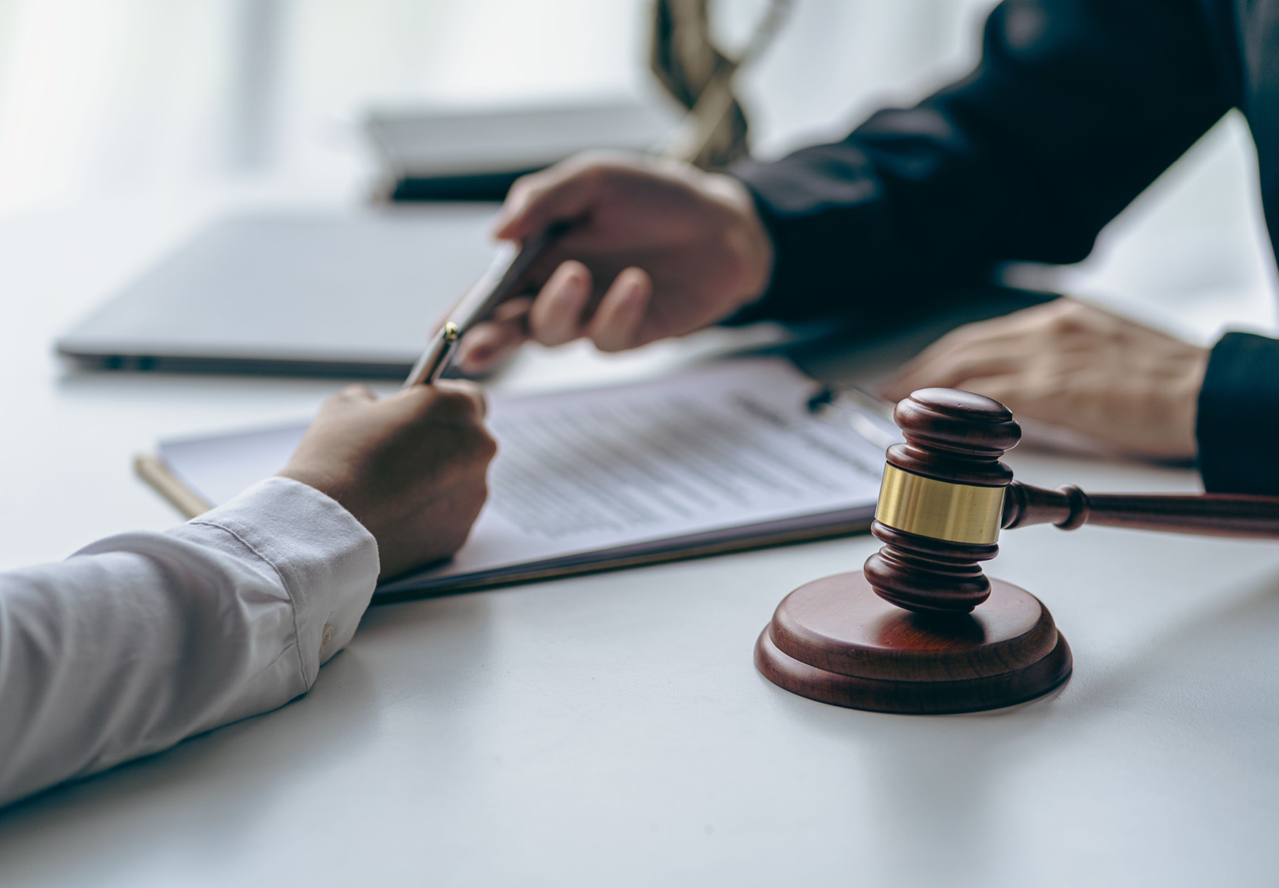 Office with sledgehammer in front lawyers and clients discussing court issues healthcare iStock Image