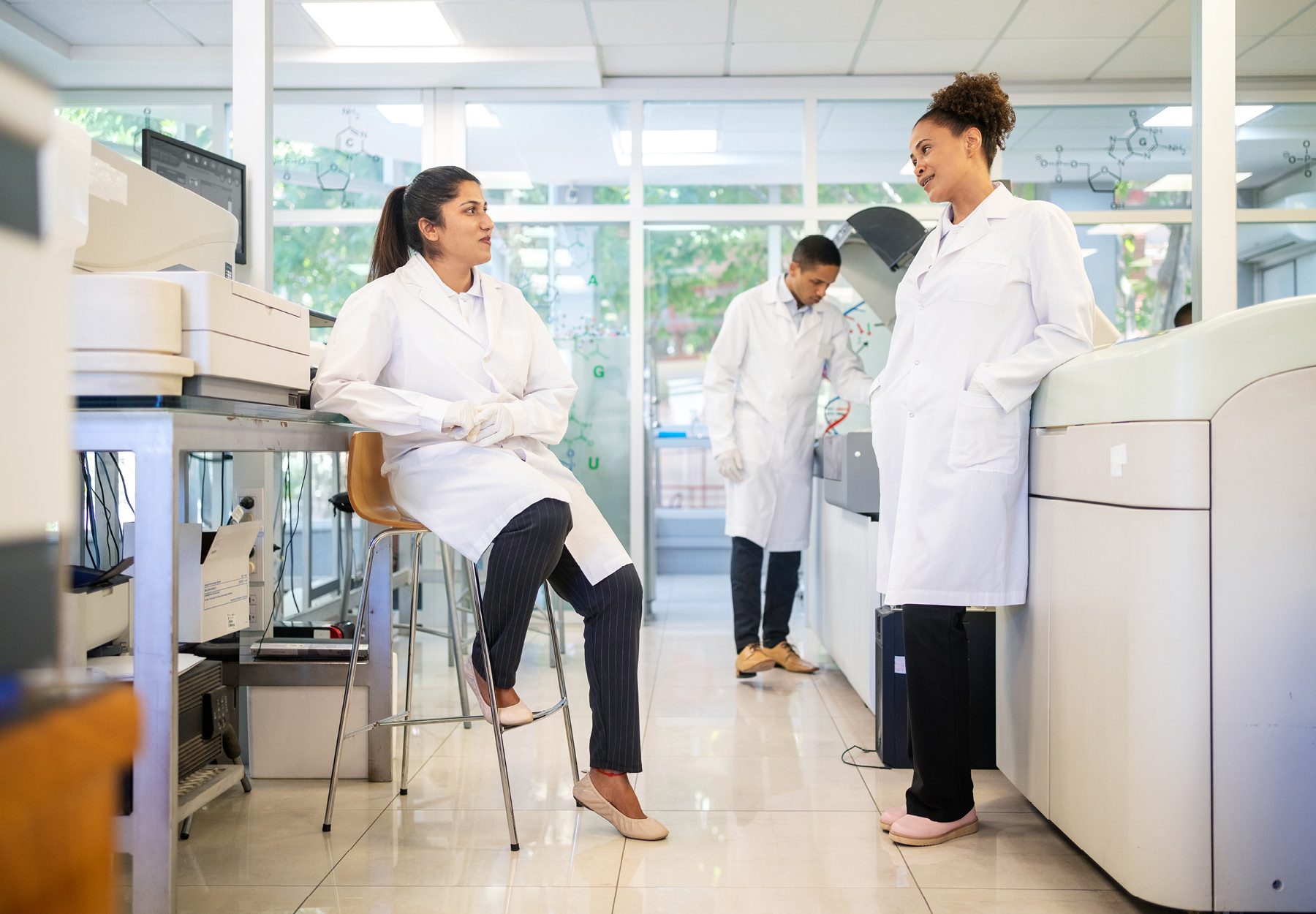 Medical lab technicians discussing work together in a laboratory iStock image