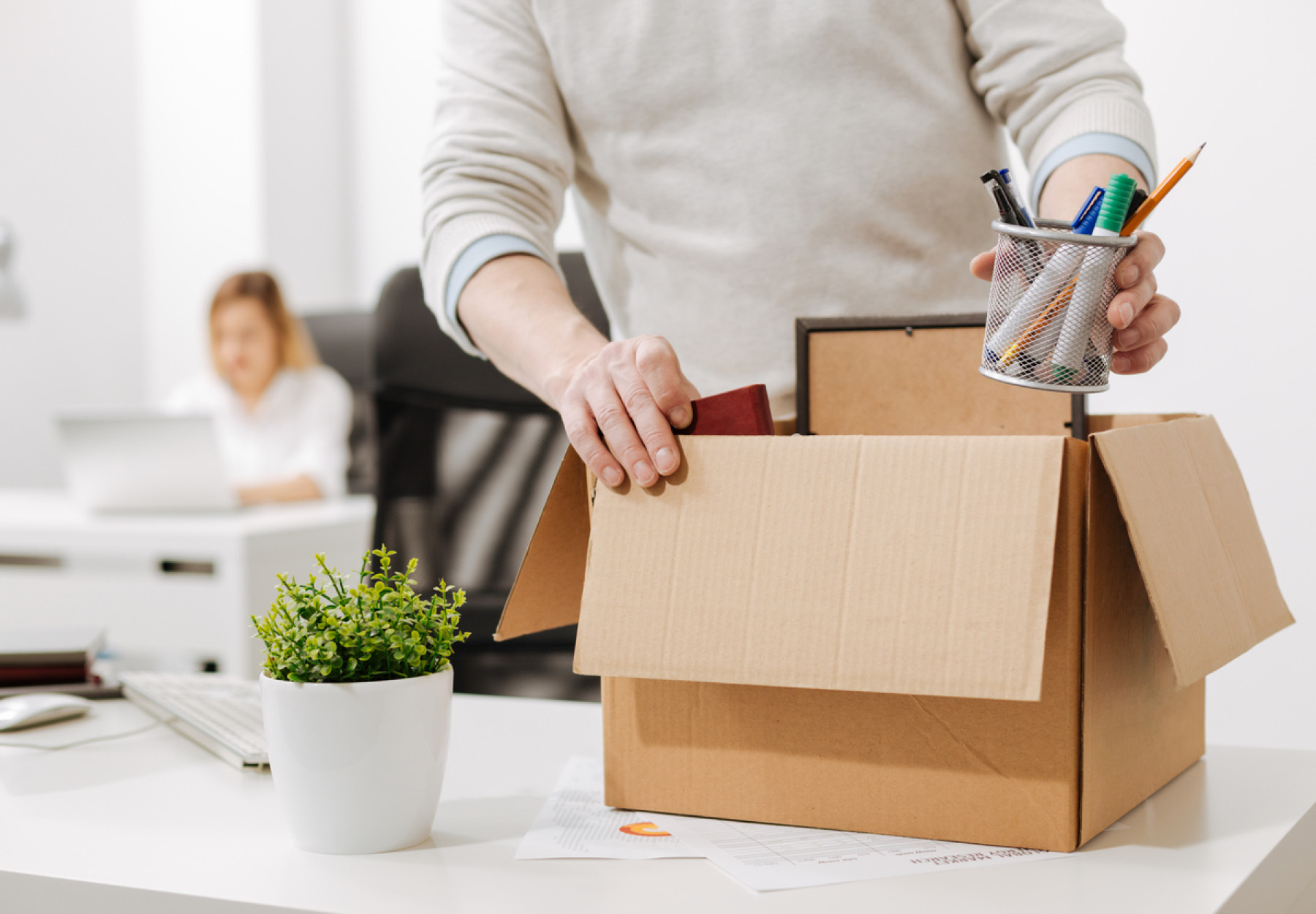 Office worker packing a box and leaving the office iStock Image
