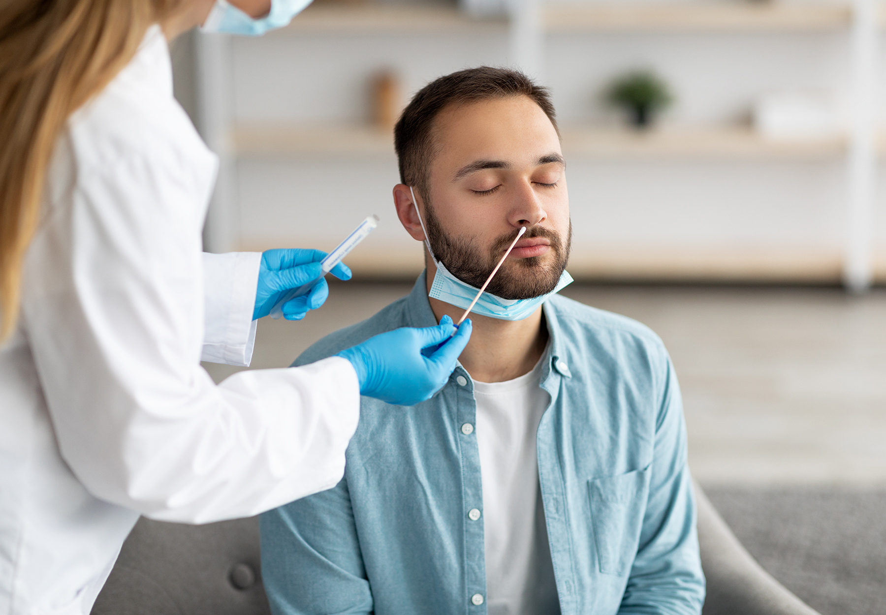 Man getting nasal swab COVID-19 test.