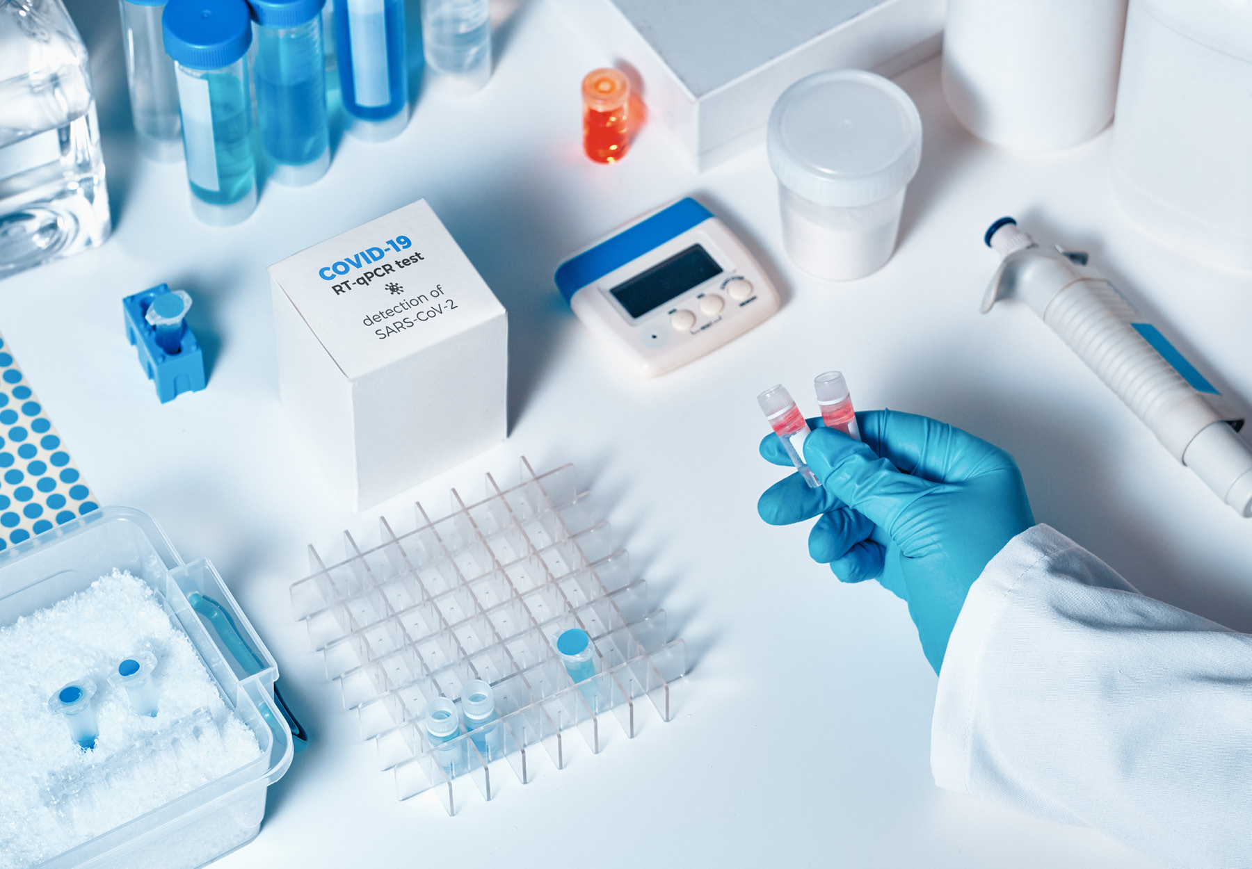 Closeup of lab professional setting up a COVID-19 PCR test on a lab bench. iStock image.