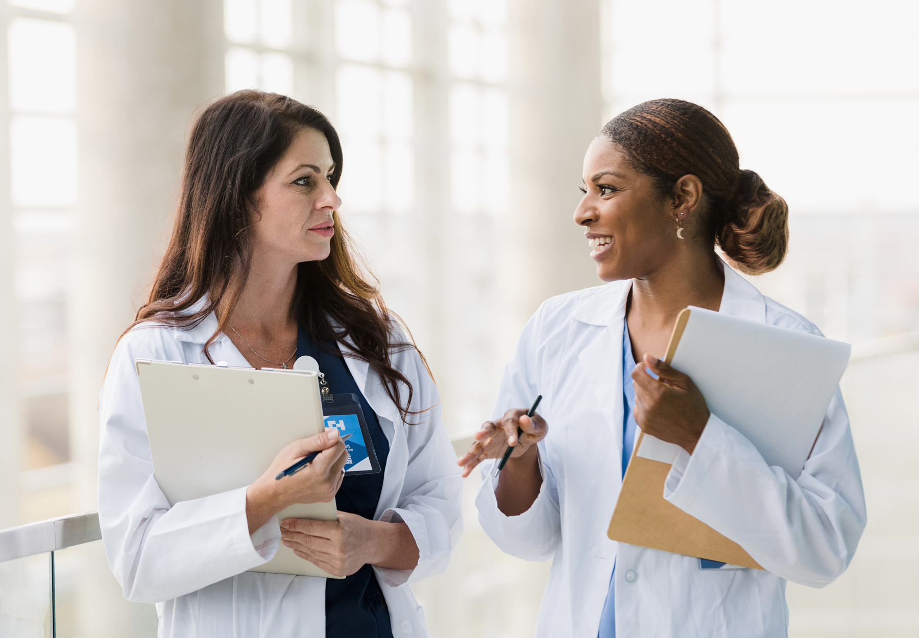 Healthcare professionals walk and talk together holder folders files istock image