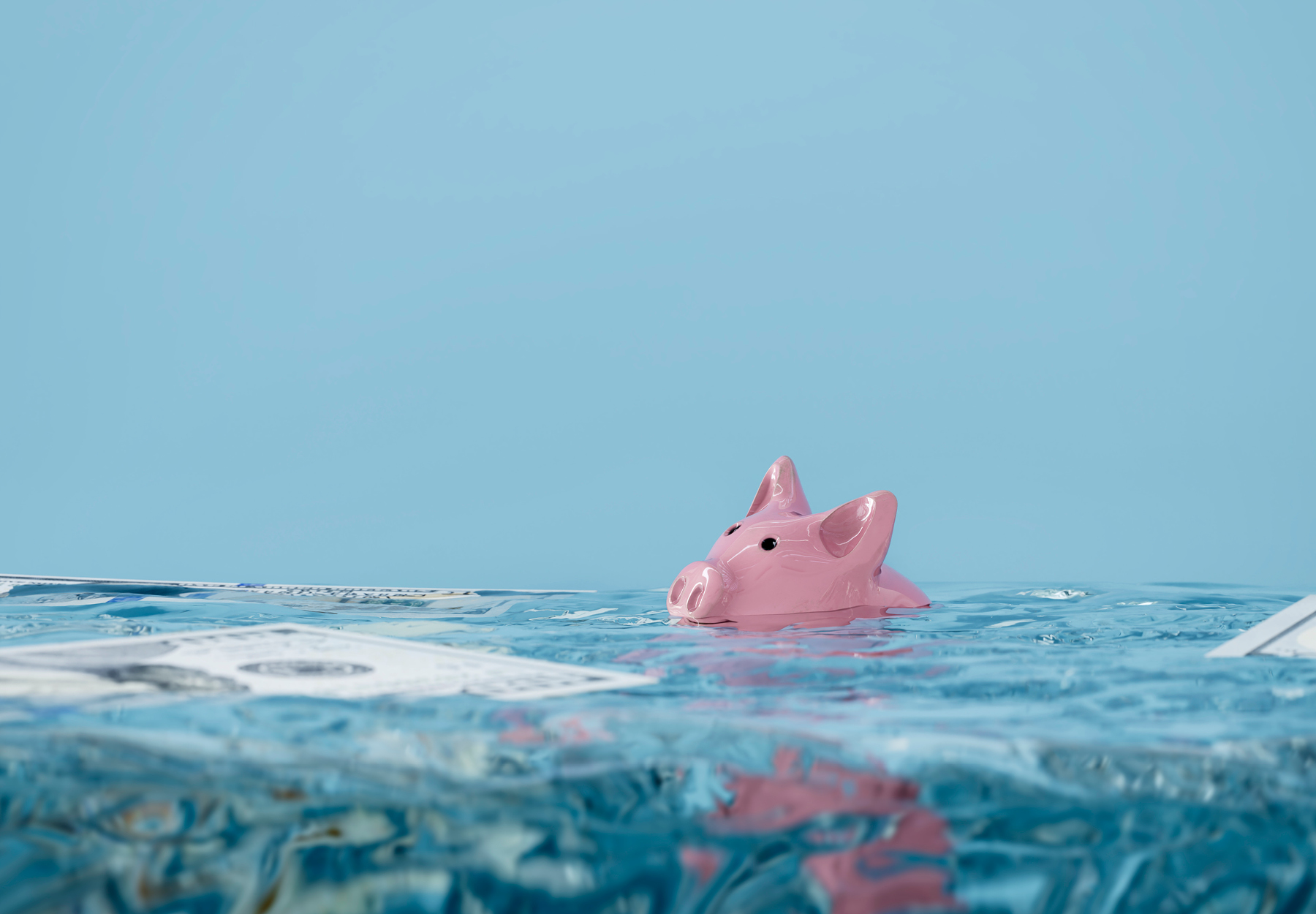 illustration of piggy bank floating in water surrounded by paper money. Economic meltdown concept. Stock image.