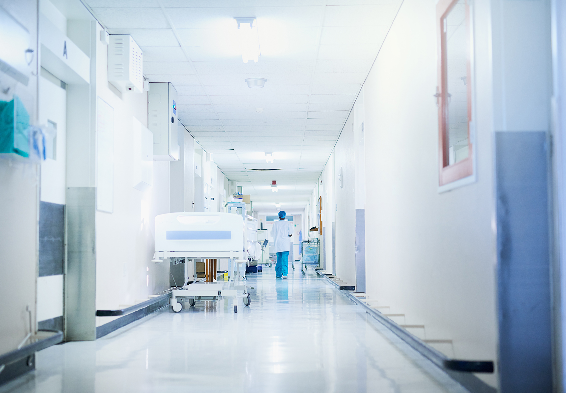Rearview shot of a surgeon walking down a hospital corridor. iStock Image.