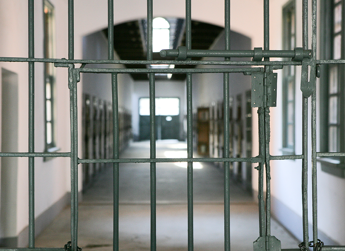 Prison hallway as seen through prison bars. Prison time concept.
