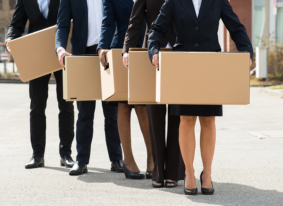 Close-up Of Businesspeople With Cardboard Boxes Standing In A Line. Layoffs Concept.