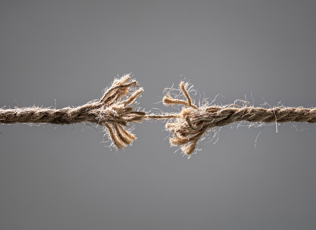 Frayed rope about to break concept for stress, problem, fragility or precarious business situation